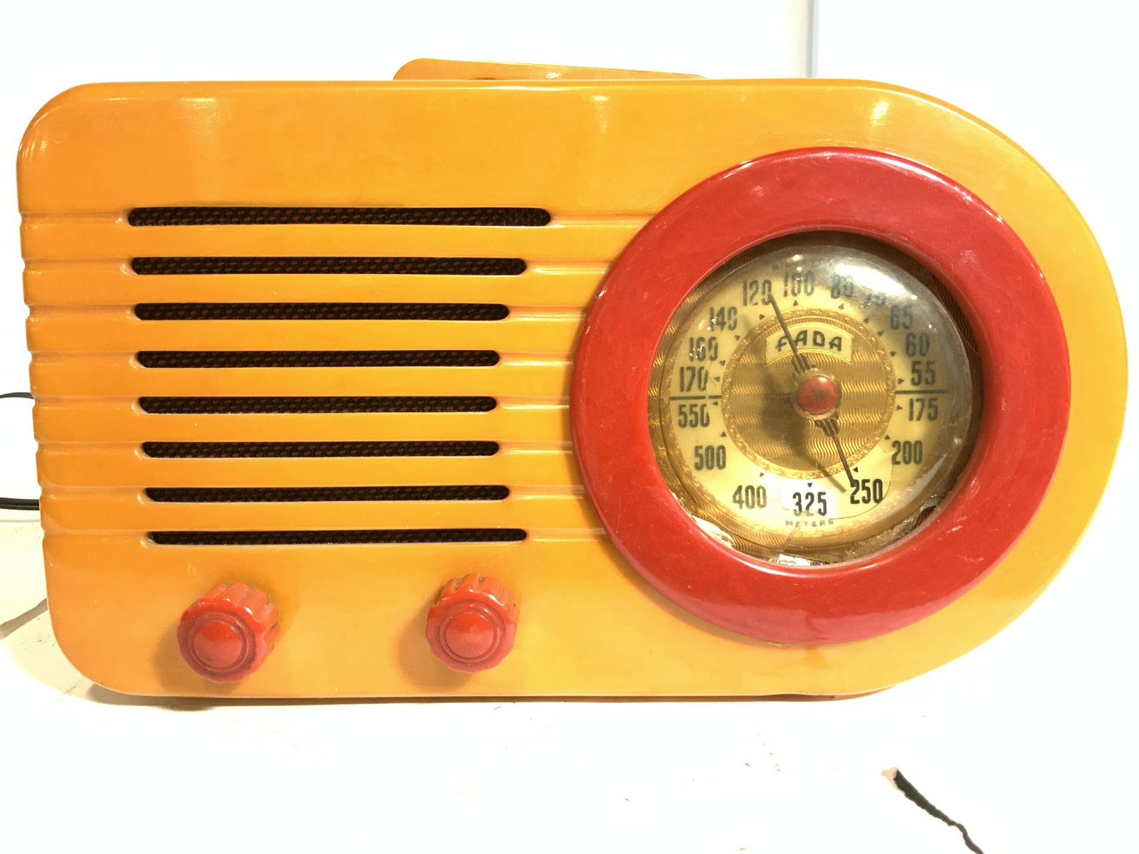 Fada Butterscotch Streamliner 1940s Bullet Radio: 1946 Fada Model 1000 AM Bullet Radio in Butterscotch and red. Introduced in 1941, and re-introduced in 1945, it used a Catalin plastic cabinet. stream lined designs of the Art Deco era and one of the 