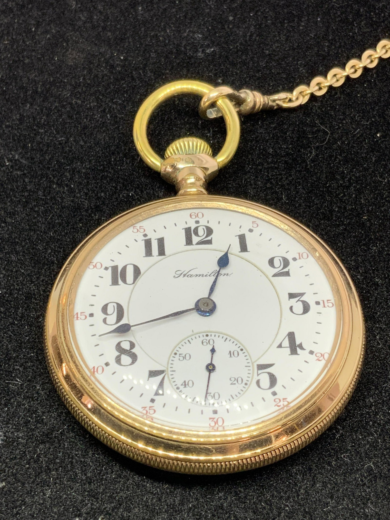 Vintage KREMENTZ FOB & HAMILTON Pocket Watch: A gold tone chain and pocket watch combo. The chain is signed KREMENTZ. Cable chain design. Signed on the clasp and right before the bail of the pocket watch. Watch has a white face with black numberi