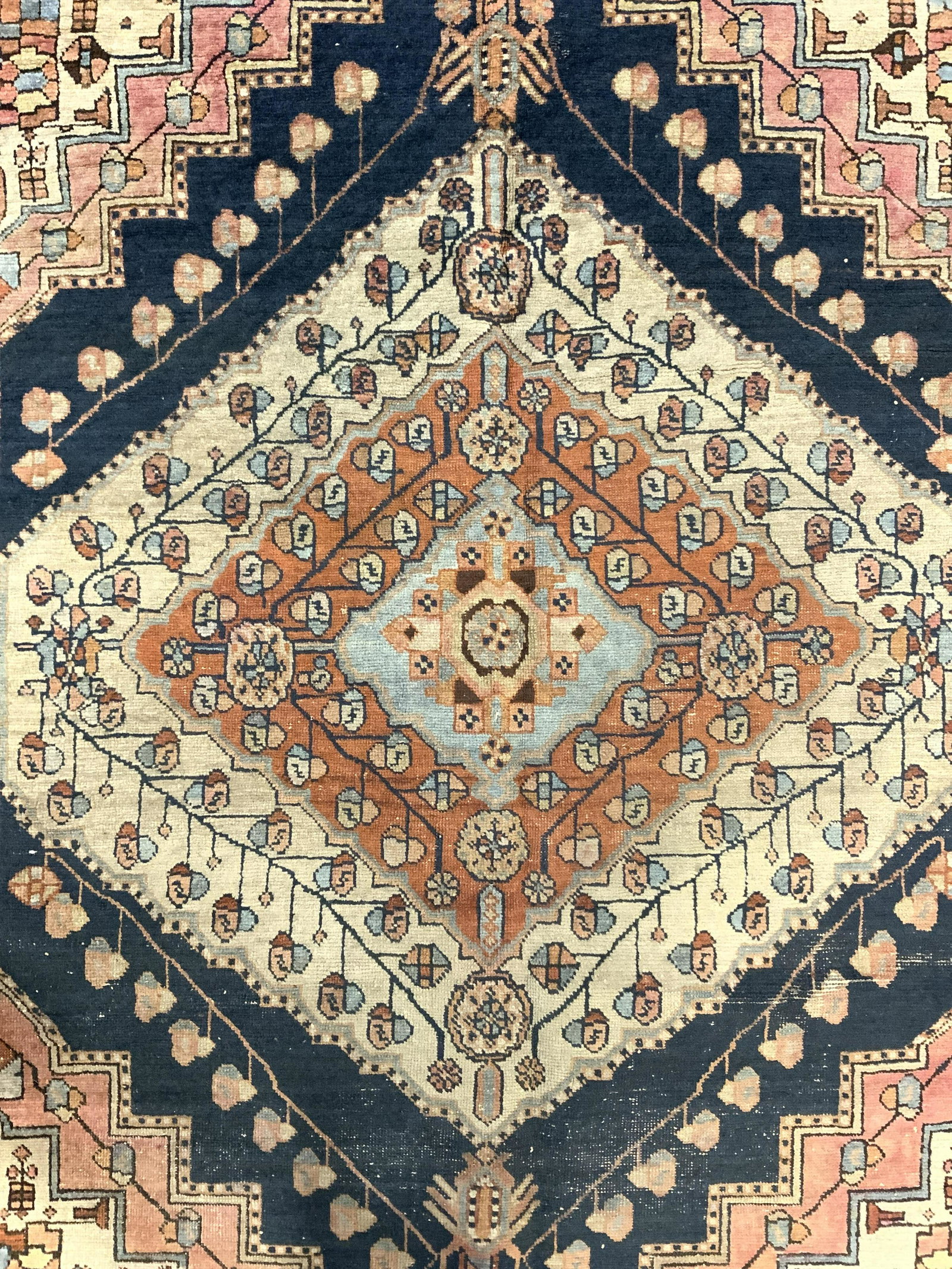 Vintage Handmade Wool Area Rug: Rug is wool & appears to be handmade. Piece has multi toned geometric & floral detail. Rug measures approx 67 inches long 52 inches wide. Rug, wool rug, area rug, vintage rug, textile arts and crafts.