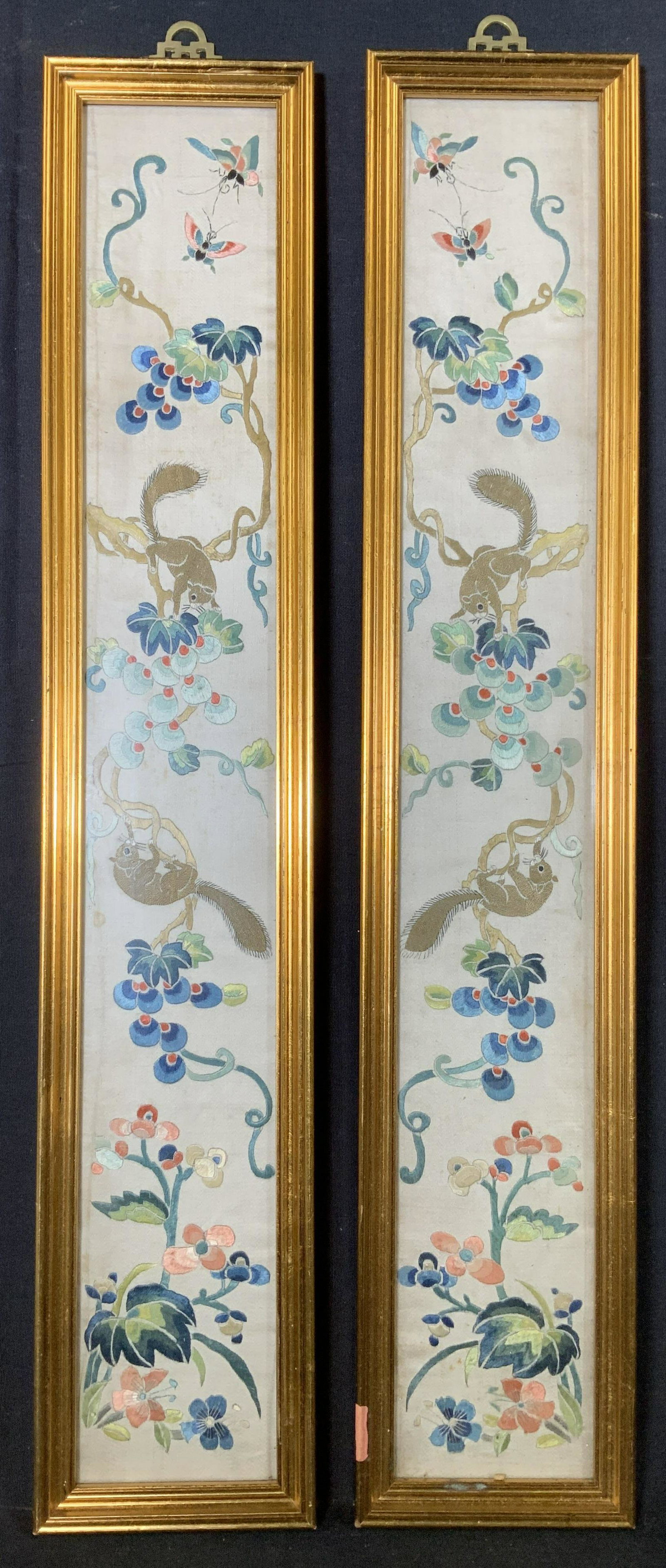 Pair Asian Embroidery Artworks with Squirrels: Pair Embroidery Artworks with Squirrels, appears to be Asian, no apparent inscriptions or signatures, subject squirrels running amongst branches, both measure 23 1/4 x 4 3/8 inches, gilt wooden frame,