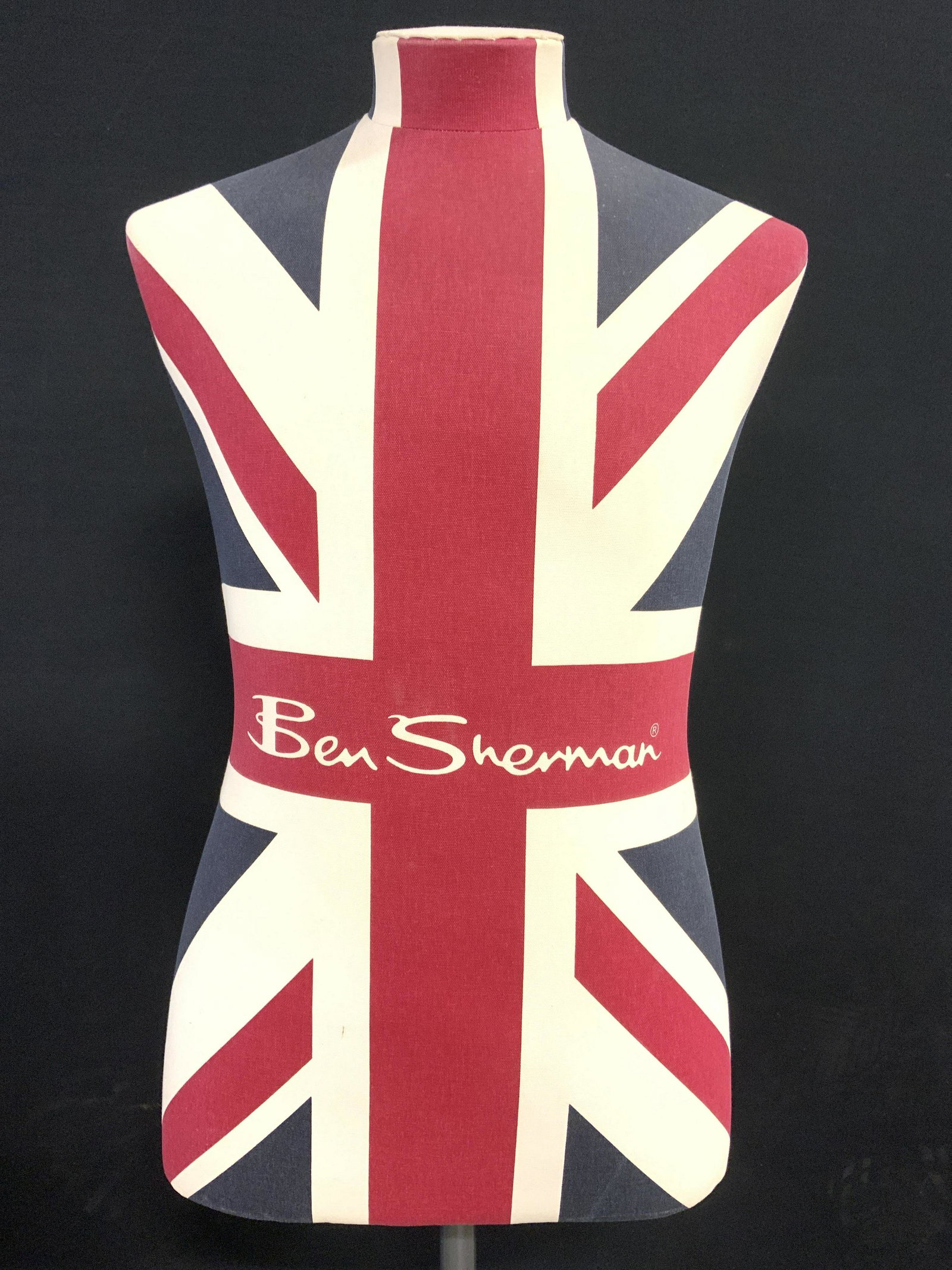 UNION JACK BEN SHERMAN Display Mannequin: Mannequin reads BEN SHERMAN on frontside. Piece has Union Jack flag detail. Mannequin sits on metal base with 4 wheels. Piece appears to be adjustable. Ben Sherman, Ben Sherman Mannequin, Union Jack m