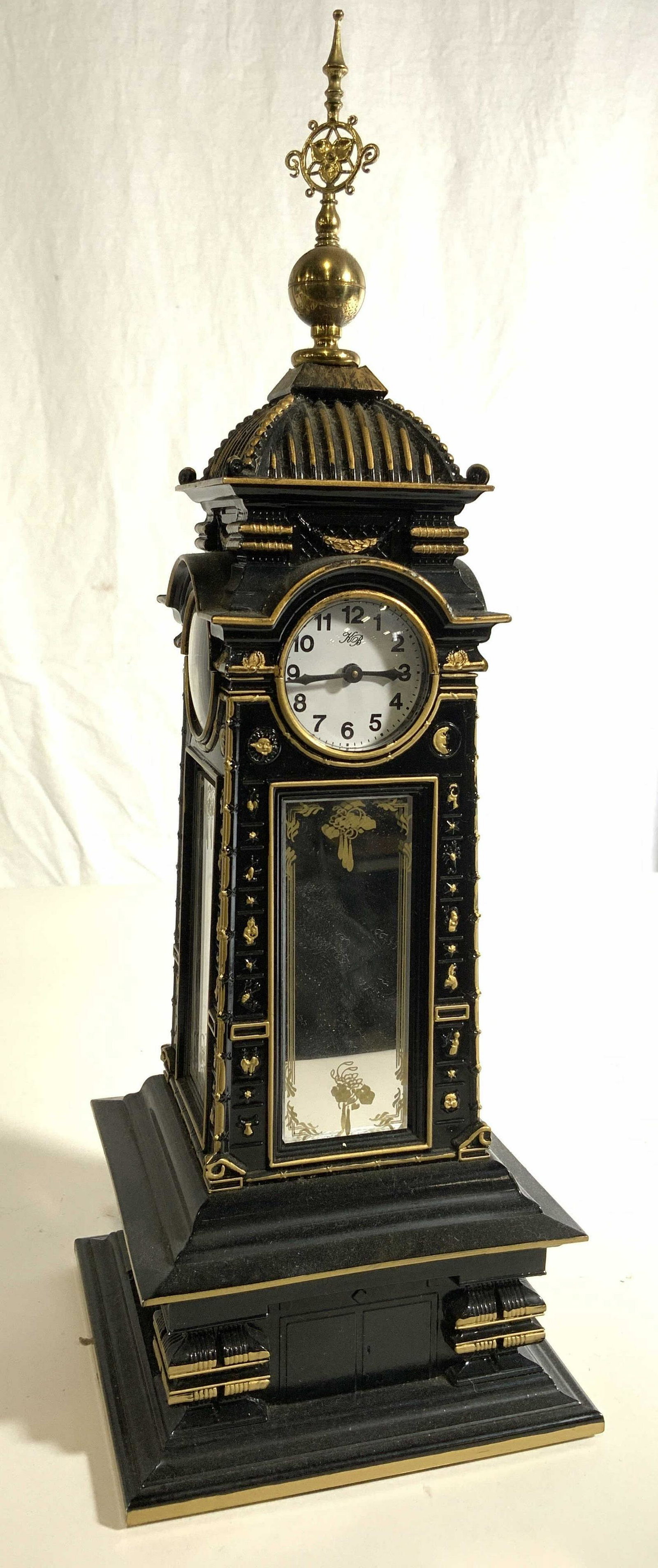 KB Mirrored Gothic Style Clock Tower Figural: Each of the 4 Clock faces reads KB. Clock has gothic style. Piece is black with gold toned accent detail and finial on top. Piece appears to possibly be vintage. Appears to be made from composite mate