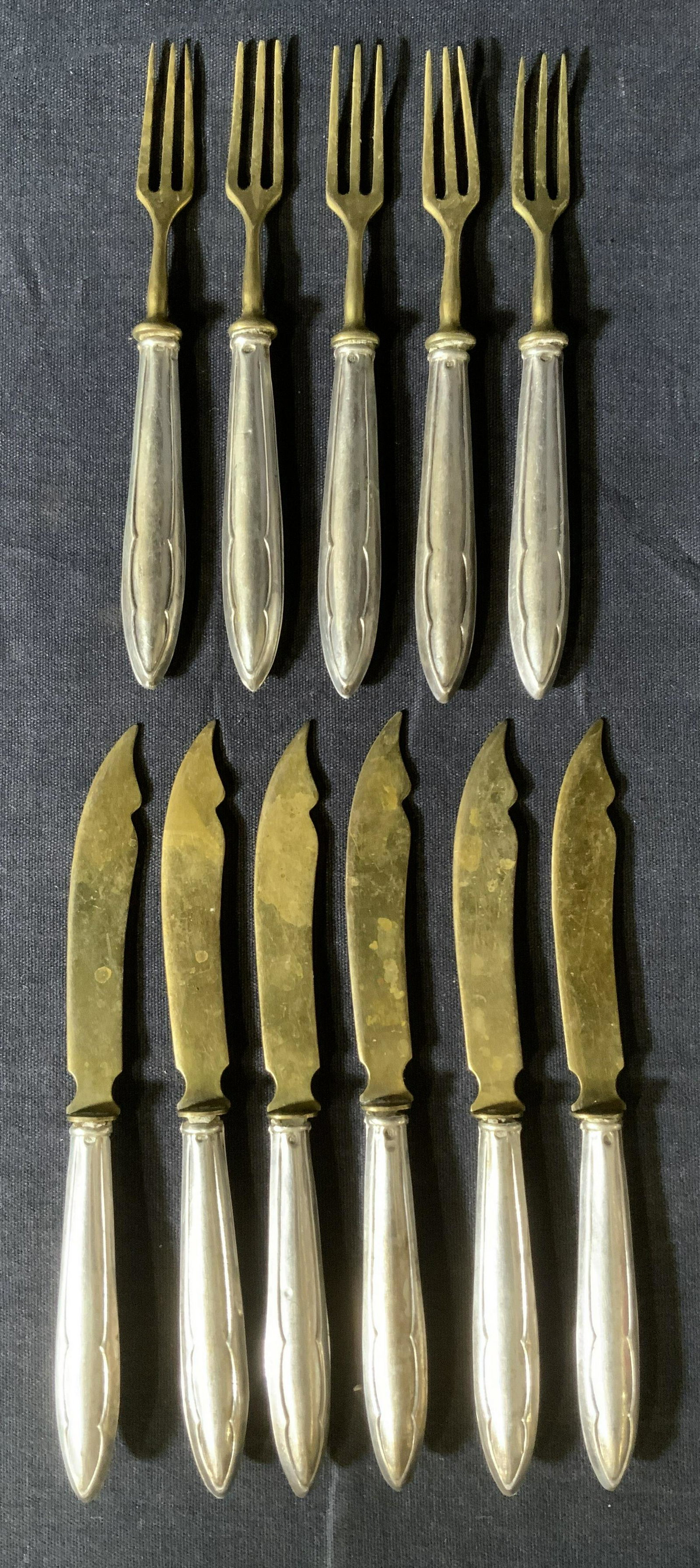 Set 11 Sterling Handled Cocktail Forks & Knives: Set 11 Sterling Handled Cocktail Forks & Knives, inscription to handles reads ‘BL’, forks measure 5 1/4 inches long, knives measure 5 7/8 inches long, total weight: 5,59 ozt, surface wear and tarn