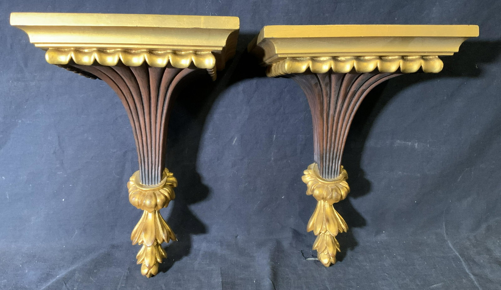 Pair Gilt Wood Hand Carved Shelf Wall Sconces: Pair gilt wood hand carved shelf wall sconces, no apparent inscriptions or signatures, gilding to the top part and acanthus leaf bottom of pieces, pieces are nearly identical, evidence of repair to on