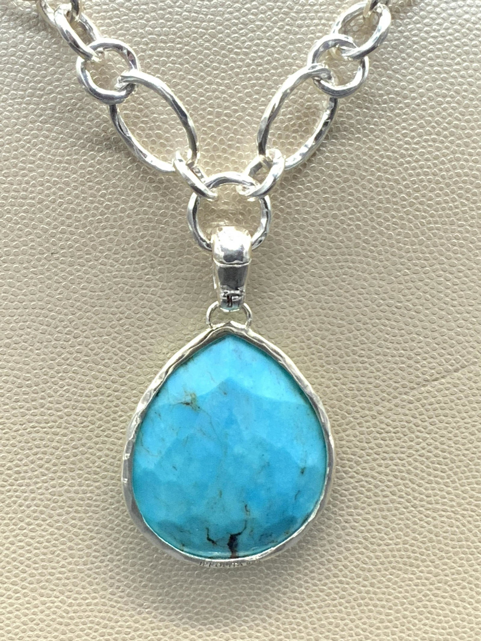 IPPOLITA Sterling Silver Turquoise Necklace W/ Bag: A sterling silver necklace with a polished & faceted teardrop turquoise pendant. The piece is signed and marked 925 near the toggle clasp closure. Also marked and signed on the base of the pendant set