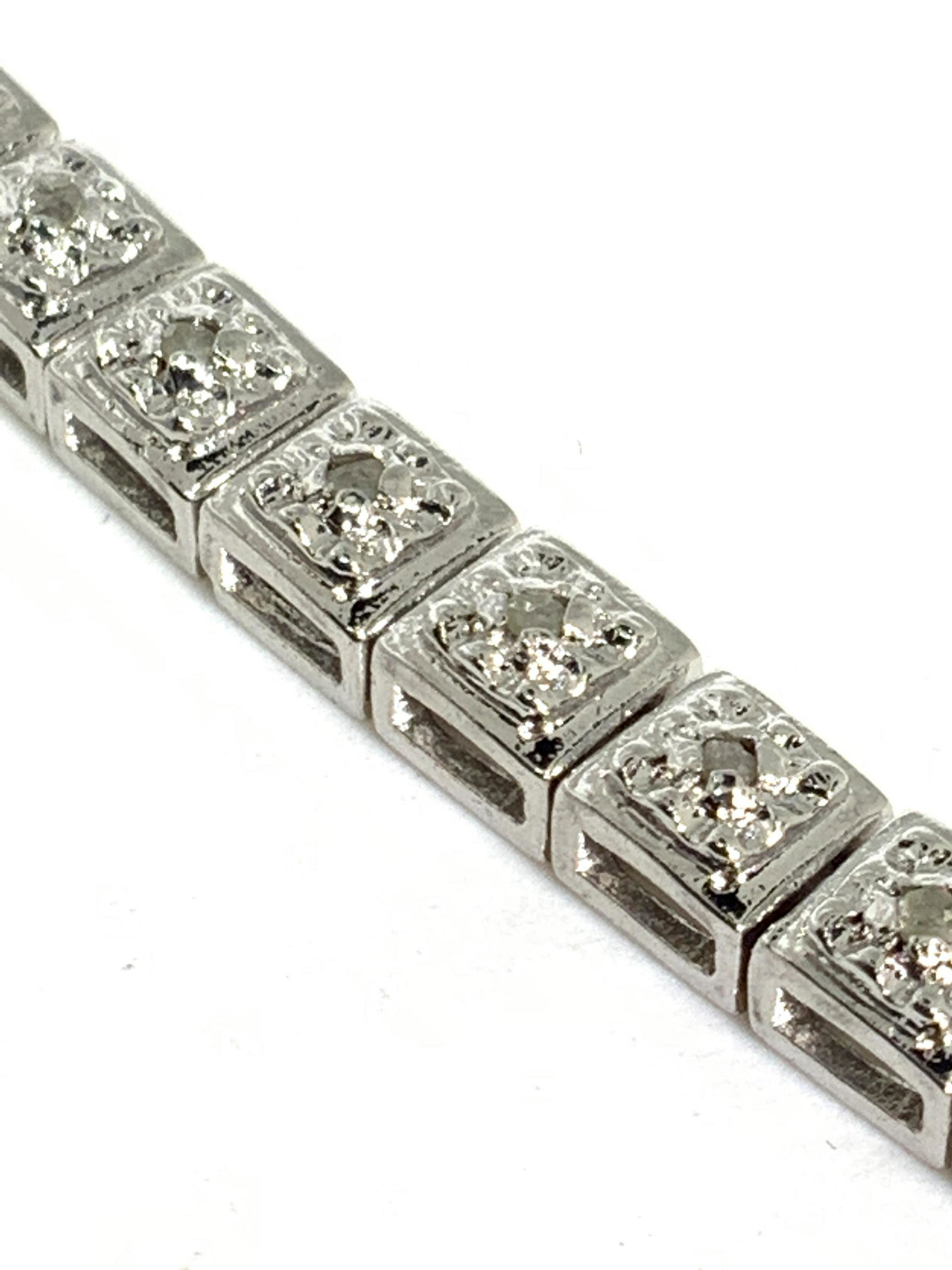 .32CT Diamond Tennis Bracelet W/ Box: A .32CT diamond tennis bracelet. The metal appears to be platinum. Each polished metal bracelet box link is accented with a diamond. Piece secures with a box clasp closure. 41 diamonds on total, 41 li