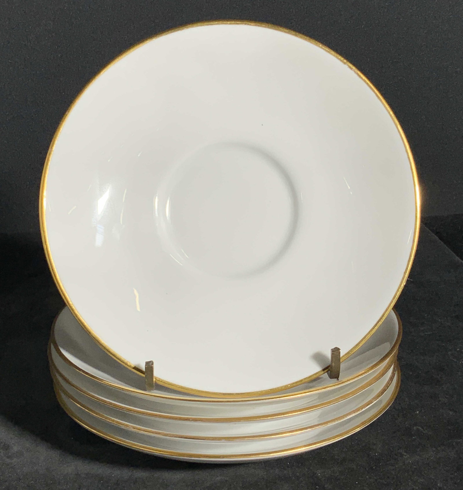 Set 5 SPODE COPELAND’S English China Plates: Five white porcelain / China plates with gilt accents. Gilt borders the rim of each plate. The underside is stamped SPODE COPELAND’S CHINA, ENGLAND. Approx, 5.5 x 5.5 in. Some wear to pieces consist