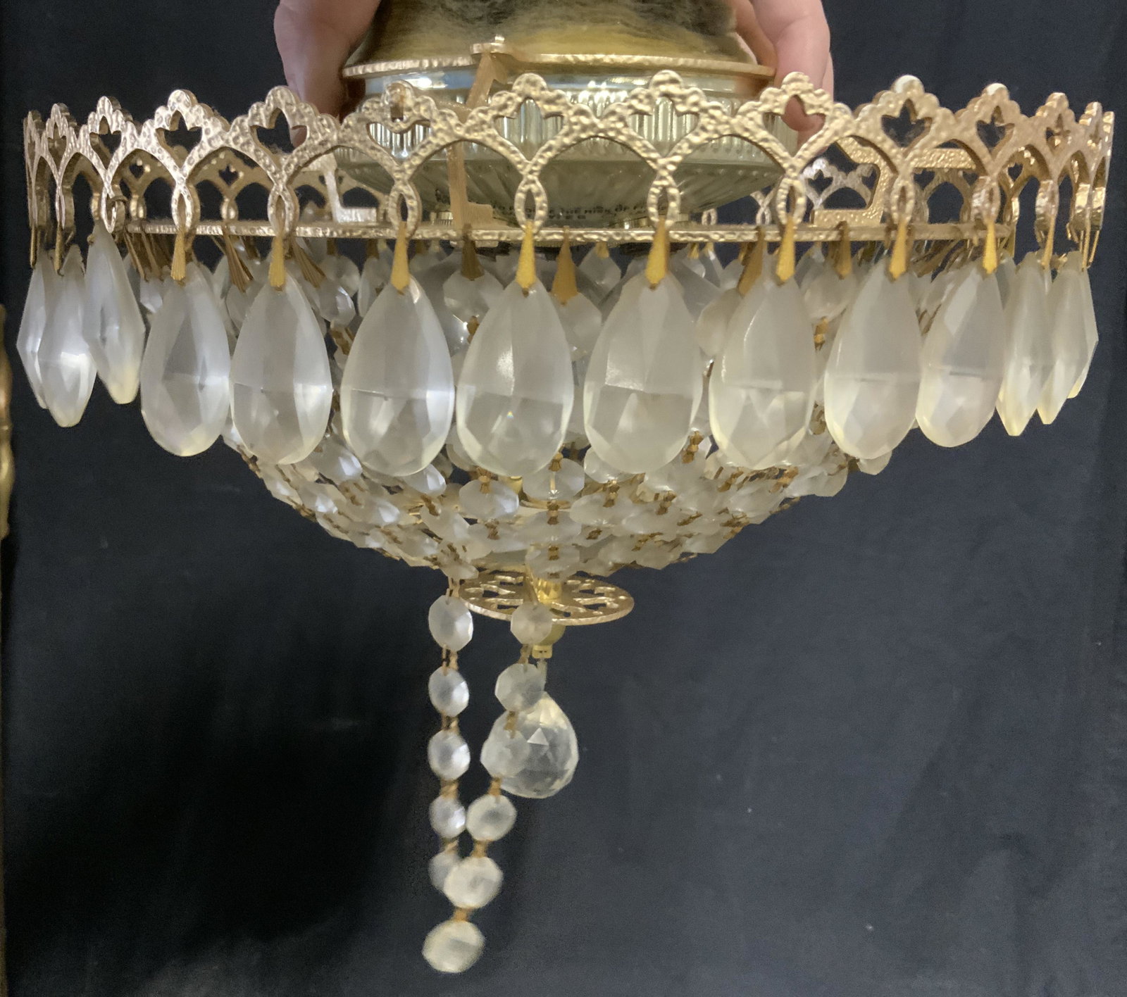 Vintage Cut Crystal Light Fixture: Vintage cut crystal light fixture, holds three bulbs. Decorated with multiple chains of cut crystal prisms. Outer rim decorated with tear drop crystal prisms. Measures approx 8.5 inches H, and 12 inch