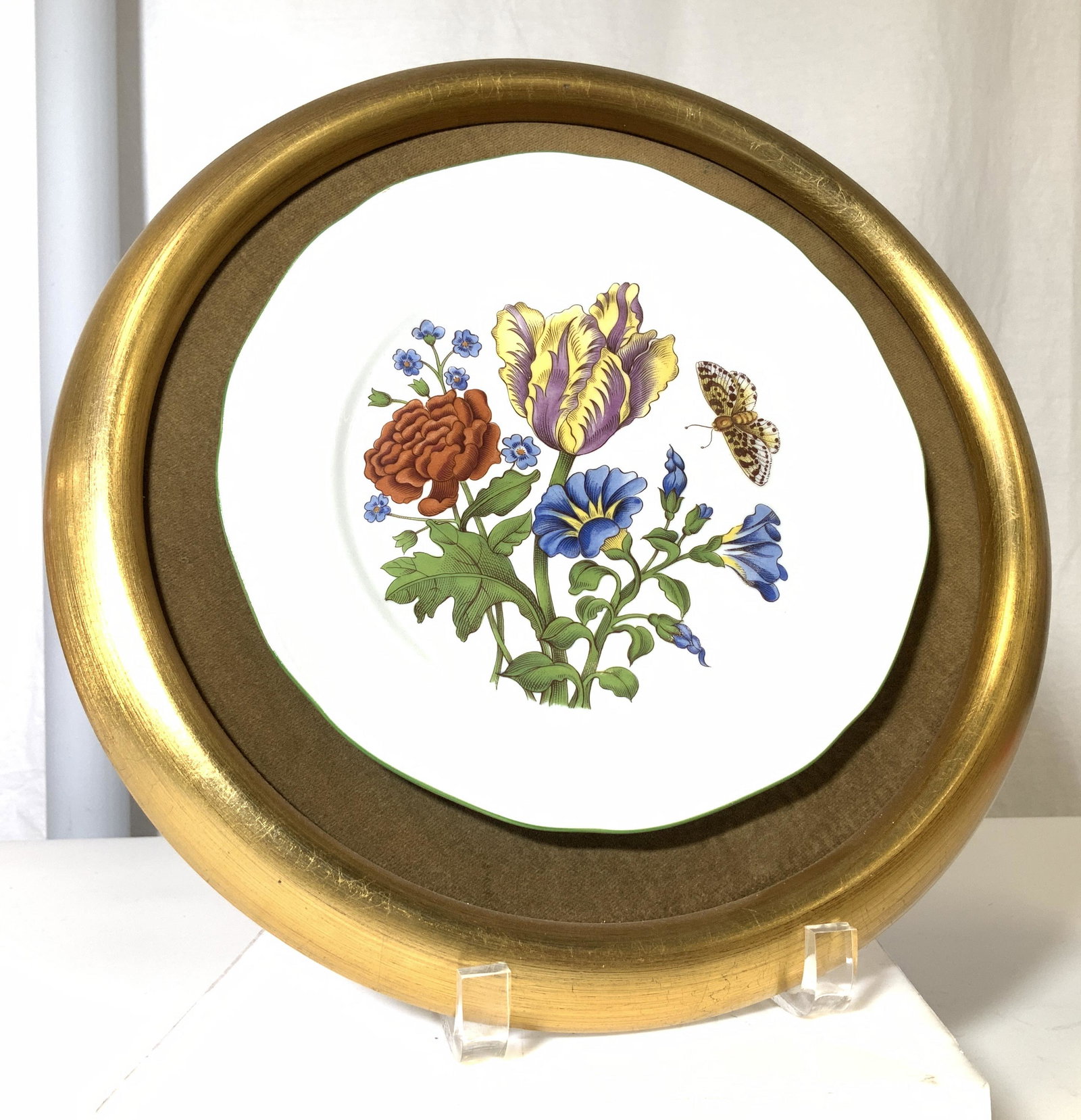 Hand Painted Botanical Porcelain Plate Display: Gilt Wood and velvet open framed Mount with hand painted porcelain plate centered, revealing crisp white porcelain and botanical florals, all hand painted. Butterfly with blue and auburn wild flowers.