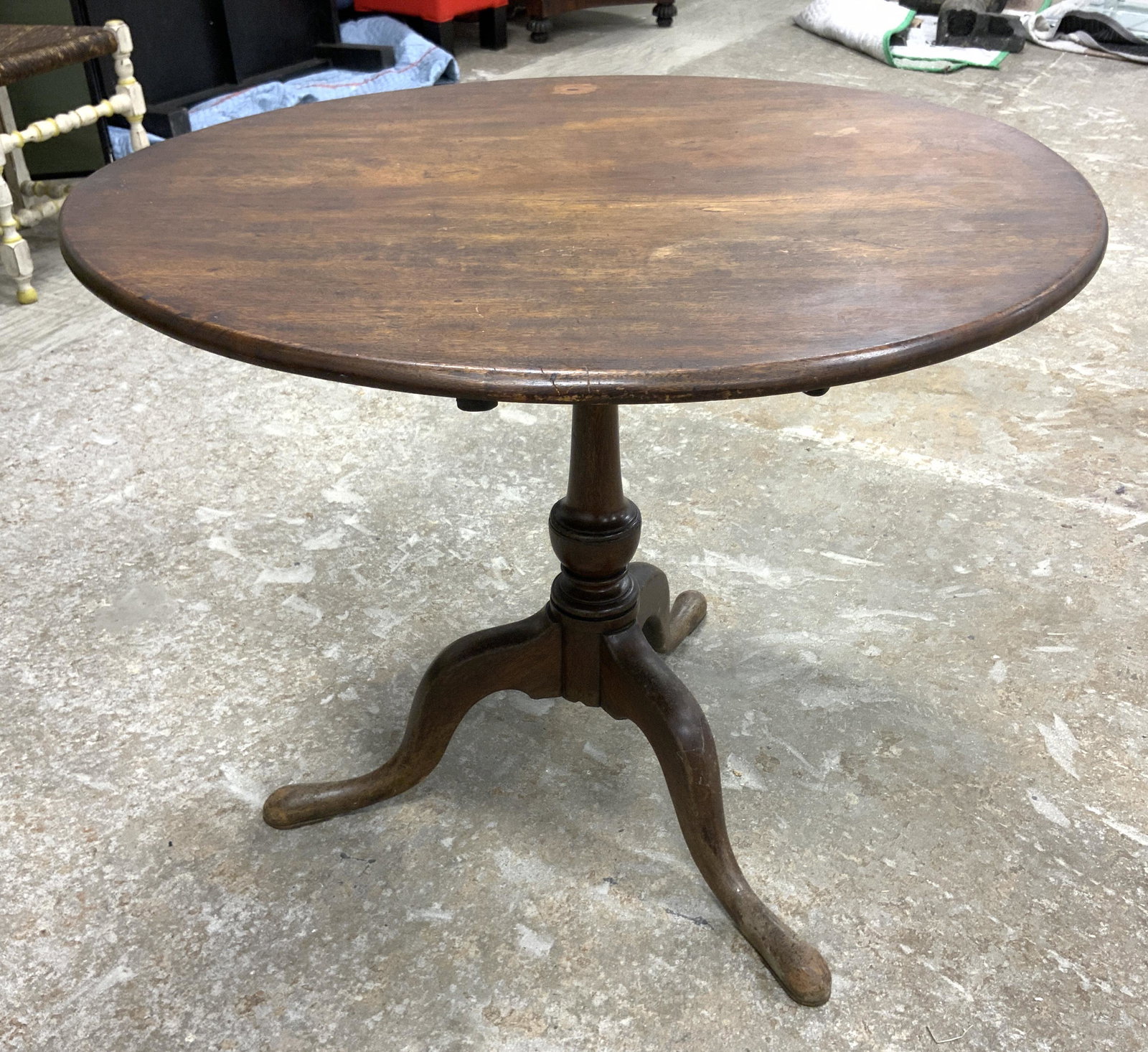 Vintage Wooden Occasional Table: Vintage wooden table. Table sits atop a column supported by three legs. Measures approx 27 inches H, and 32.5 inches in diameter. Wear is consistent with age and use. Table top can be folded for stora