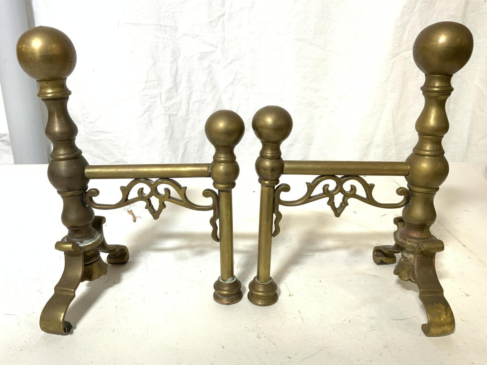 Pair Petite Vintage Brass Andirons: Andirons are vintage possibly antique. Each piece is brass and petite in size. Each side of each andiron has s curve detail. Each measures approx 9 inches tall 6 inches deep 4.5 inches wide. Andirons,
