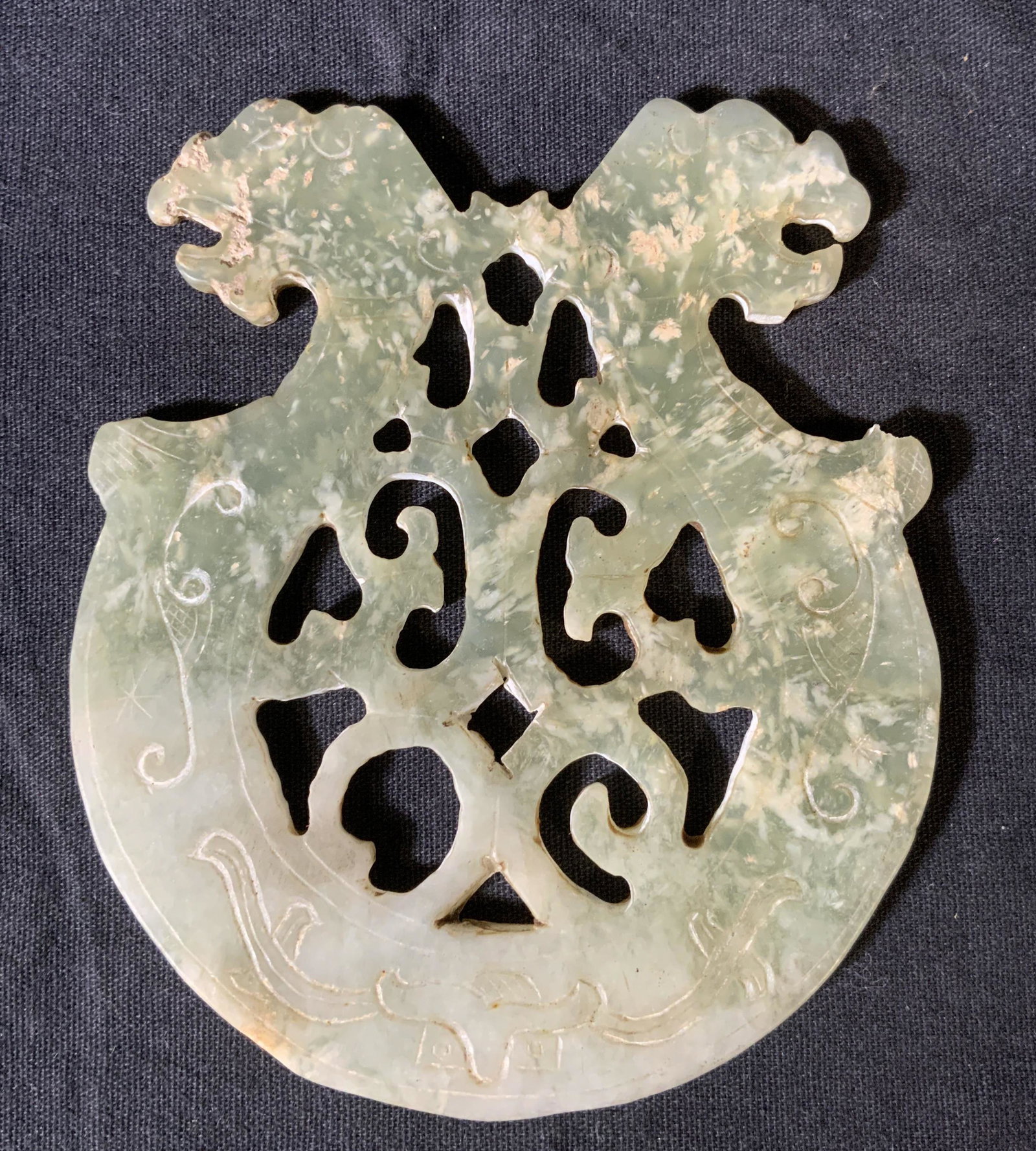 Chinese Jade Dragon Ornament: Chinese Jade Ornament, no apparent inscriptions or marks, design features two dragon like creatures, measures 4 1/2 x 3 7/8 inches at widest point, some surface wear and losses to stone, Chinese Decor