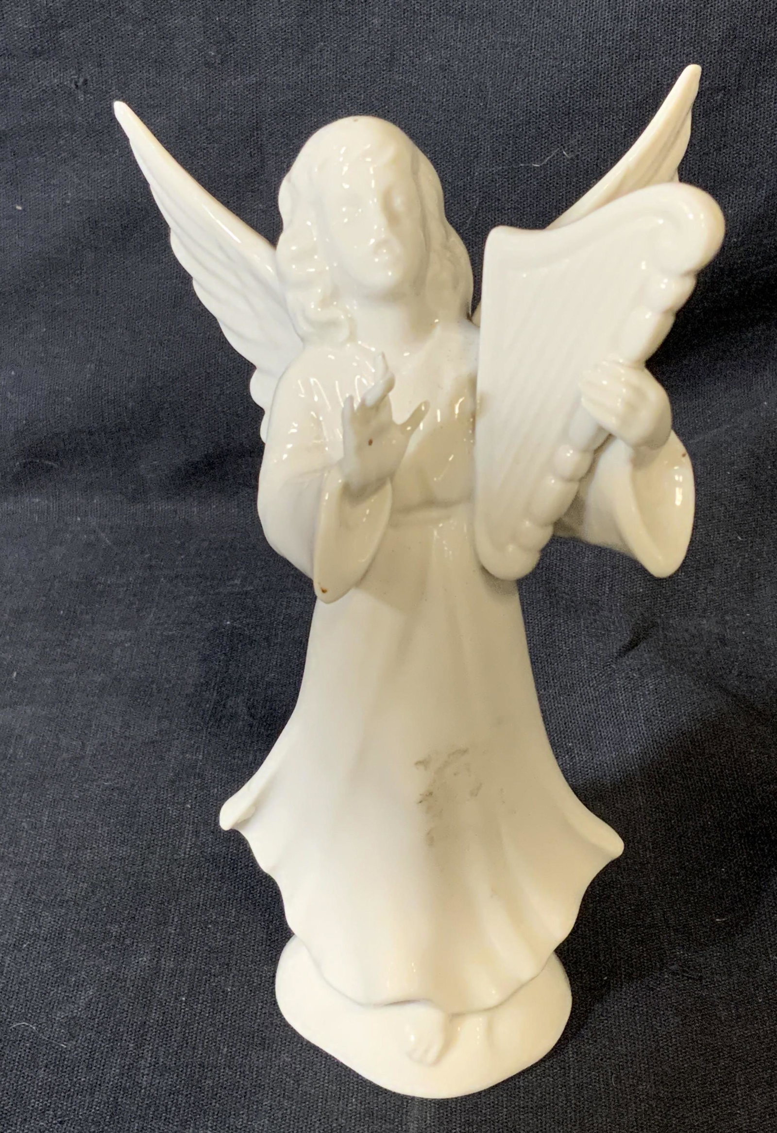 German Porcelain Angel Figural: German porcelain angel figural, stamp to underside reads ‘Original Germany’, subject a female angel holding a harp singing, piece measures 5 inches at tallest point, some wear to surface, German p