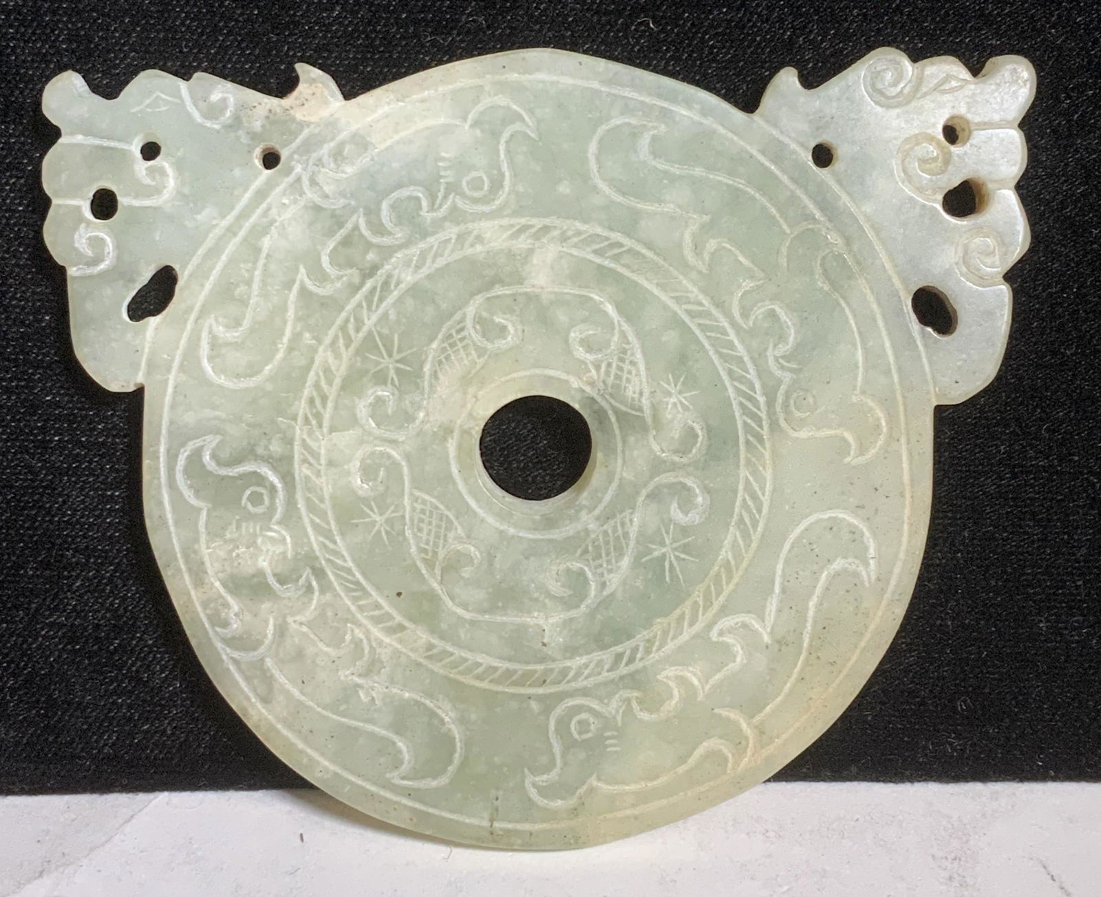Pair Chinese Jade Hand Carved Ornaments: Chinese Jade Ornament, Celadon Jade. Chinese thunder and cloud design. One ornament has holes to string as a pendant. Use as wall decor, coasters, more. Round dial Measures 4 in. Other piece measures