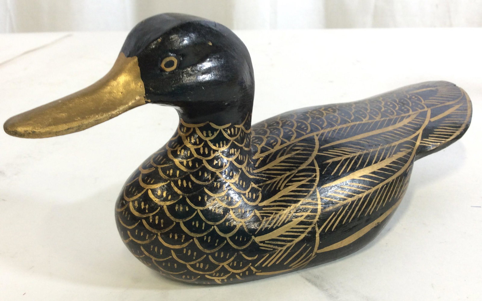 Hand Painted Wood Duck Collectible: Wood Duck Painted in glossy black with gold paint outlining his feather. Measures 10 x 4 in. Ht. 4 in. Collectible Ducks, Home Decor & Accessory, Hand Painted Wood Duck, Black And Gold Duck, Water fow