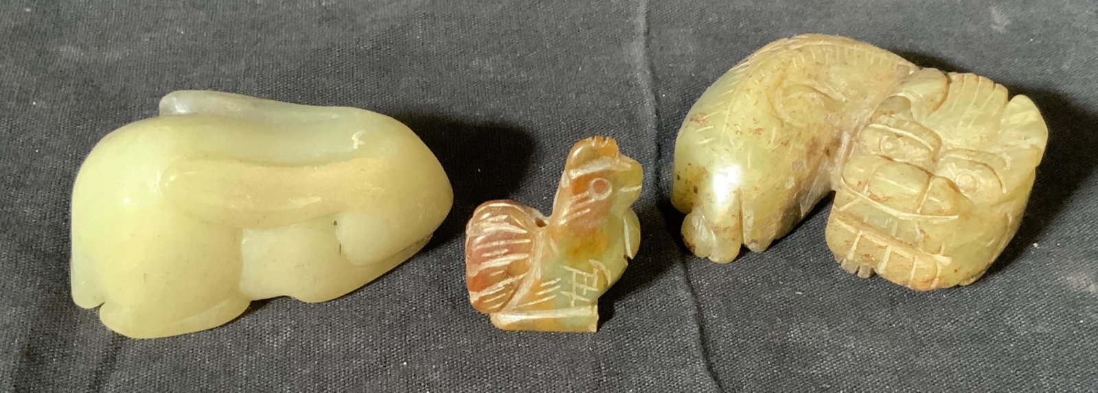 3 Hand Carved Natural Stone Animal Figures: 3 hand carved natural stone animal figures, lot includes a rabbit a rooster and a fu dog, largest of the three measures 2.5 inches long, no apparent inscriptions or markings on any of them, some scuff