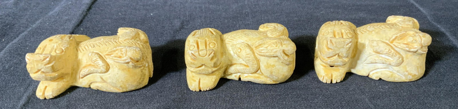 Lot 3 Recumbent Stone Qilin Figurines: Lot 3 Recumbent Stone Qilin Figurines, no apparent inscriptions or marks, a mythical beast carrying a snake, spider, frog, and lobster, all measure approximately 3/4 inches tall x 1 7/8 inches at wide