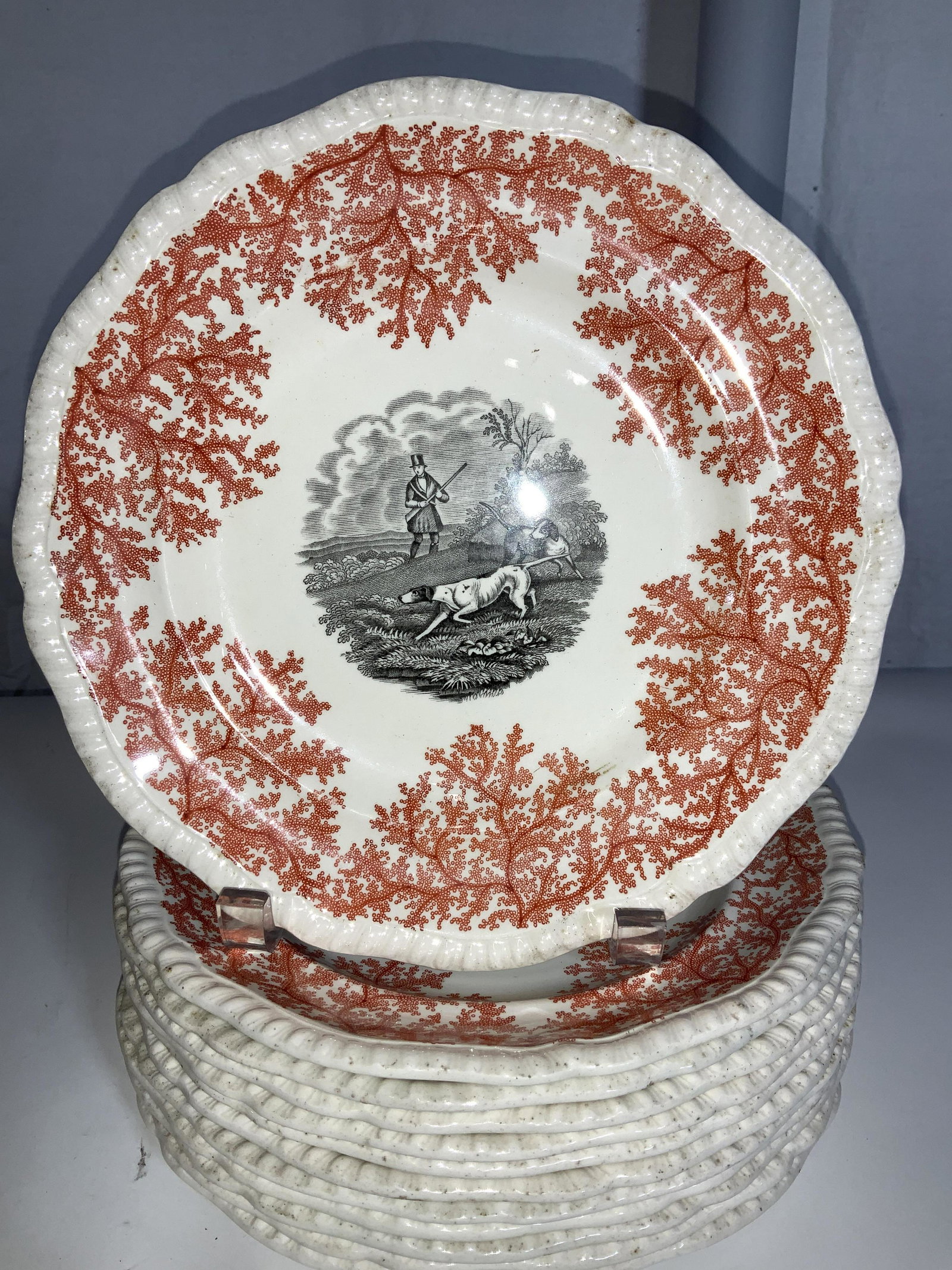 Set 12 SPODE FOX HUNT MOTIF Porcelain Plates, Eng: Cream color porcelain plates, hand painted with orange berry design, center medallion of fox hunt scene - two dogs searching for prey, distinguished man in background with firearm. Hallmarked on verso