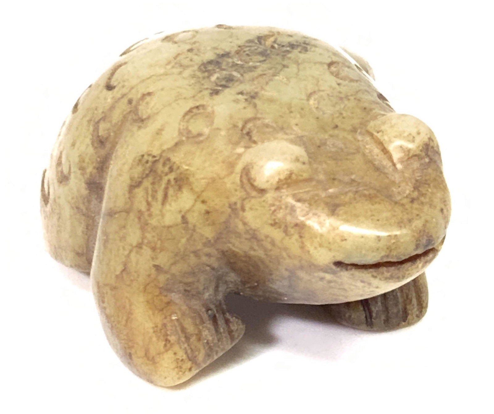 Asian Carved JADEITE Stone Frog Figural: A carved, etched, and polished jadeite frog figural. Piece stands alone, underside smooth and polished with one carved slit accent. Precisely incised and carved detail. Primarily green toned with eart