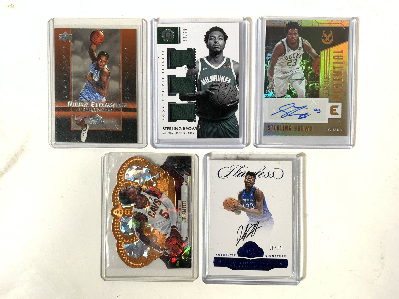 Lot 5 NBA & College Basketball Cards: Lo includes 5 basketball cards. Including JR SMITH Panini no 171. Sterling Brown Panini No RT-SB. Sterling Brown Panini No TP-SBW. Carmelo Anthony Upper Deck no 3 & Juston Patton Panini no. BRA-JP. Ea