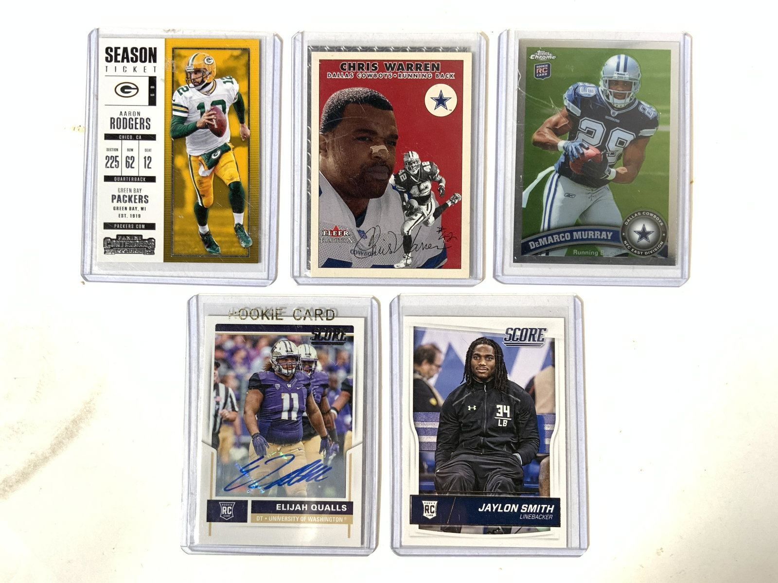 Lot 5 NFL & College Football CArds: Lot includes 5 cards including Brett Farve Panini no. 31. Chris Warren Fleer Tradition no. 28. Demarco Smith Topps no. 173. ELIJAH QUALLS panini no. 419. & Jaylon Smith Panini no. 407. Football cards,