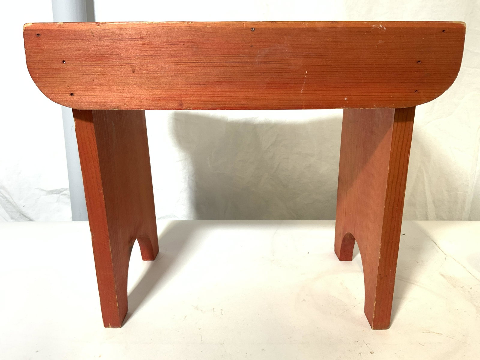 Vintage Wooden Footstool Bench: Bench is vintage possibly antique. Piece is wooden. Contains an orange wooden tone. Piece measures approx 15 inches long 12 inches tall 9.5 inches deep. Piece is possibly hand crafted. Bench, stool, w