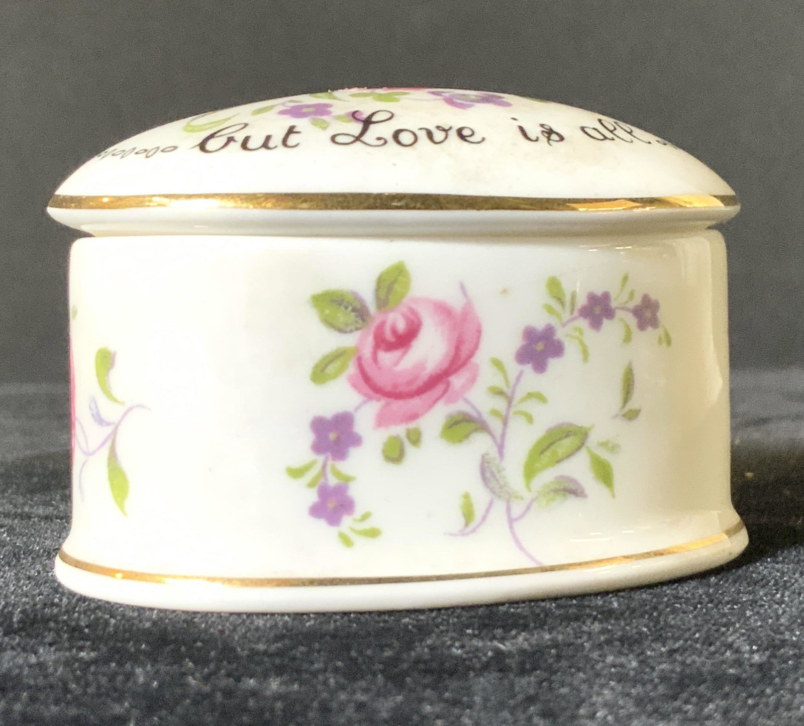 STAFFORDSHIRE Signed Fine Bone China Trinket Box: A painted and signed Staffordshire porcelain trinket box. Piece is lidded. The lid reads: THE GIFT IS SMALL BUT LOVE IS ALL. Primarily white porcelain with pink floral designs and gilt line work. The 