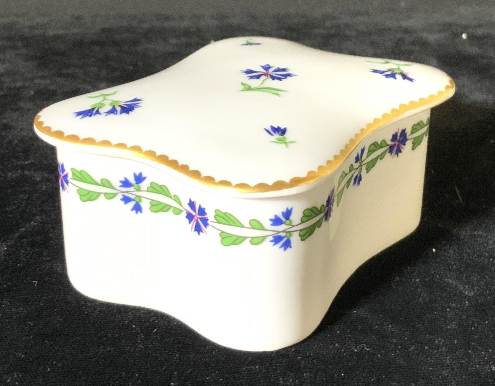 LIMOGES FRANCE TIFFANY & CO Porcelain Trinket Box: A painted and signed Limoges porcelain trinket box. Piece is lidded. Primarily white porcelain with blue floral designs and gilt line work. The underside is signed with a blue flower & writing, reads: