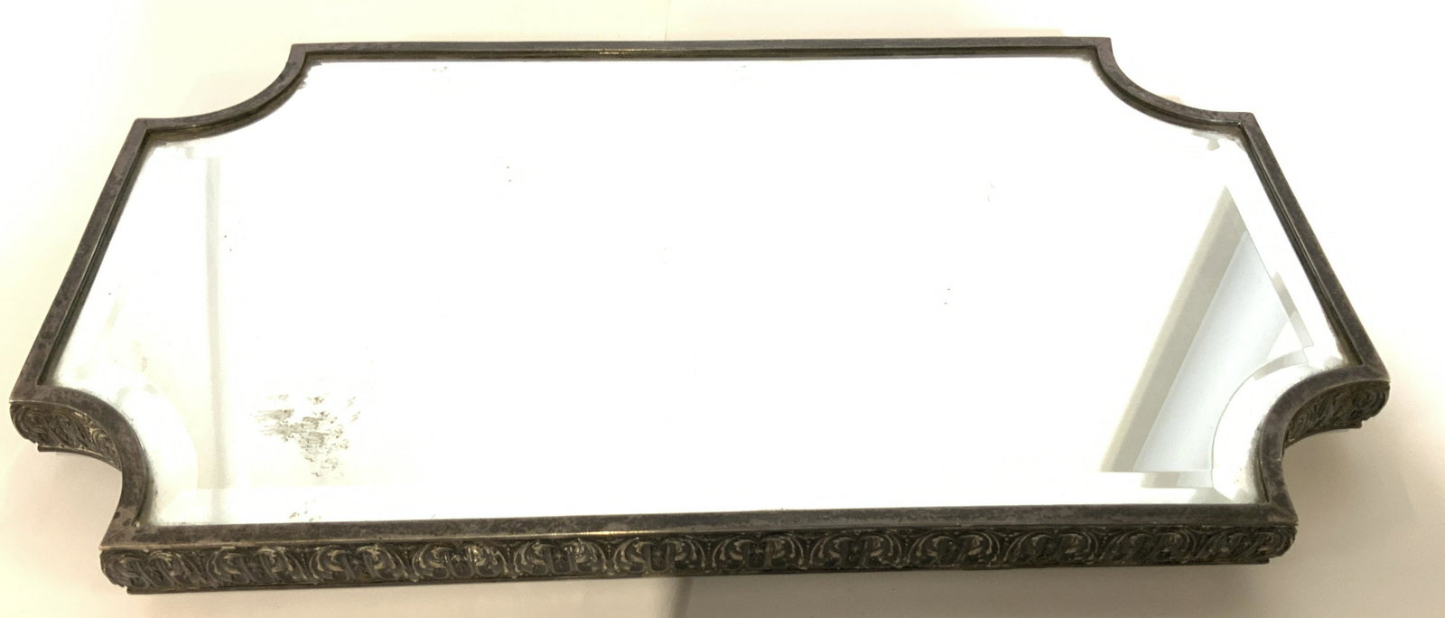 Vintage Victorian Silver Toned Mirror Vanity Tray: Chased metal solver timed tray rim, possibly silver plates, with Victorian pattern of swirls. Footed tray with silver times 1/2 orb ball feet, 2 missing. Beveled mirror, moderate surface wear consiste