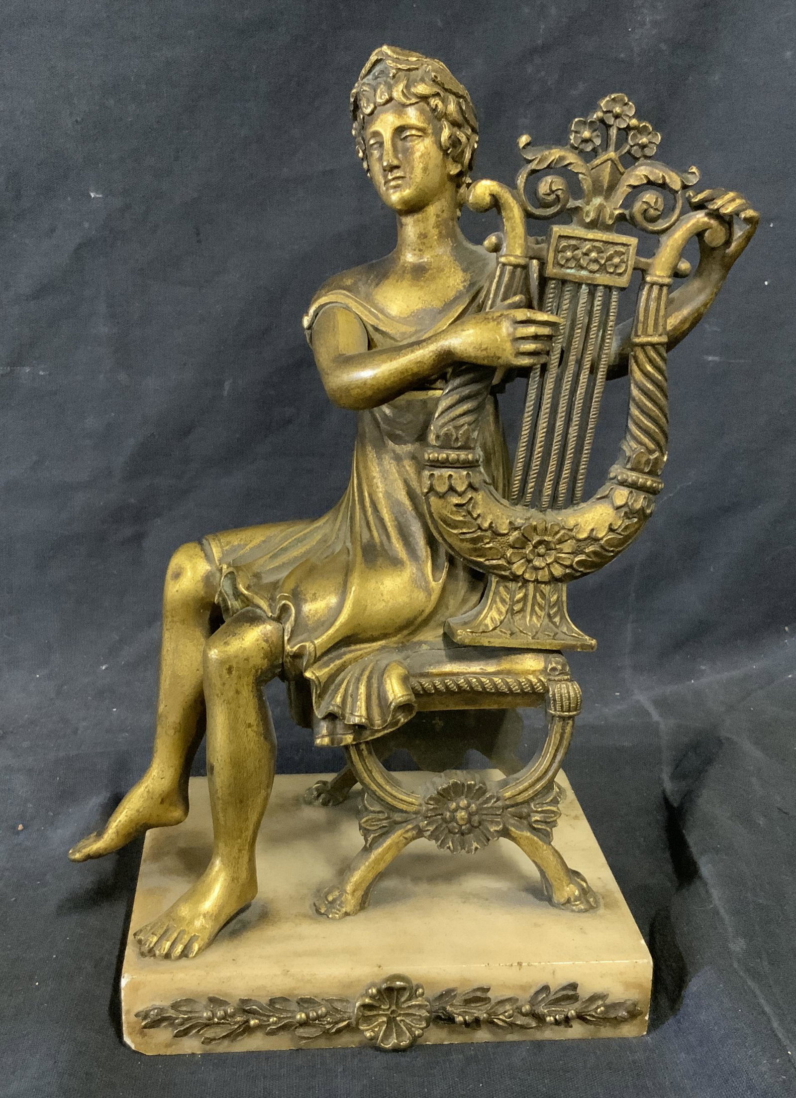 Brass & Marble Sculpture of Harp Player: Brass and marble sculpture of harp player, no apparent inscriptions or markings, subject a seated man in toga holding and playing a harp, body of sculpture is made of brass and sits atop a marble base