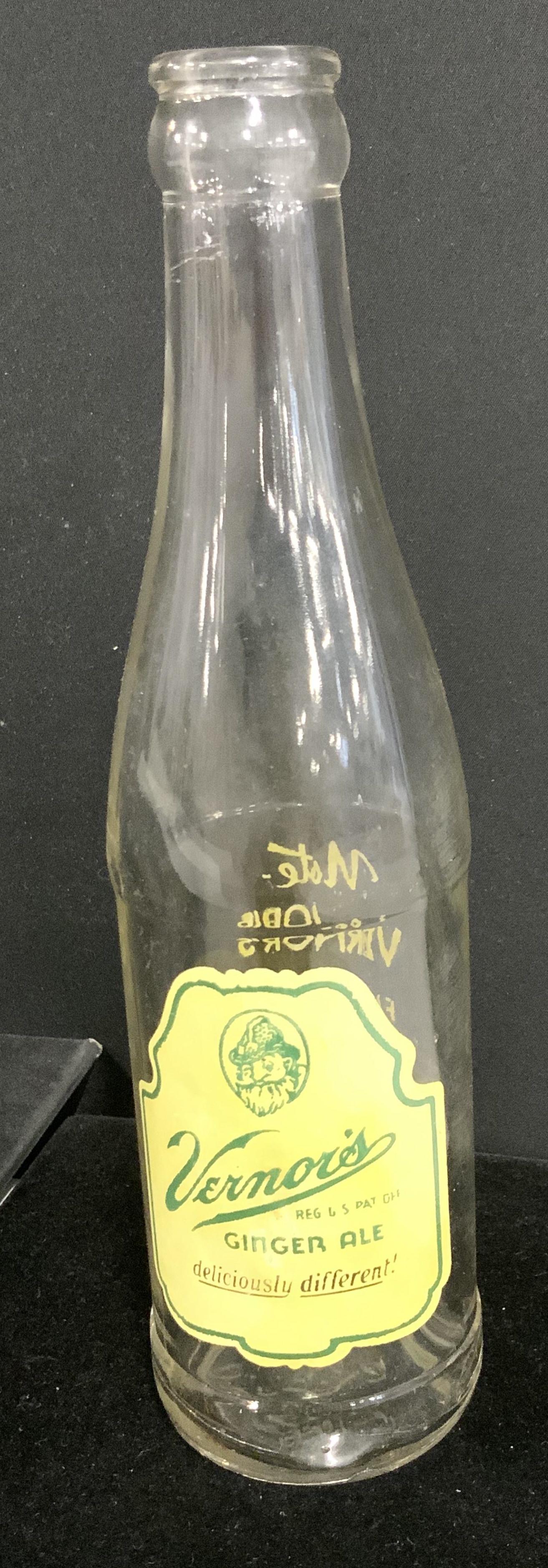 Collectible VERNOR’s GINGER ALE BOTTLE: Bottle cap ale glass beverage bottle, mid century, Hallmarked. Glass itself has impressed Registered mark on verso, reads 2-47; 10; G-1093. 8.5 in. Ht. Collectible ginger ale soda bottle, vernor’s v