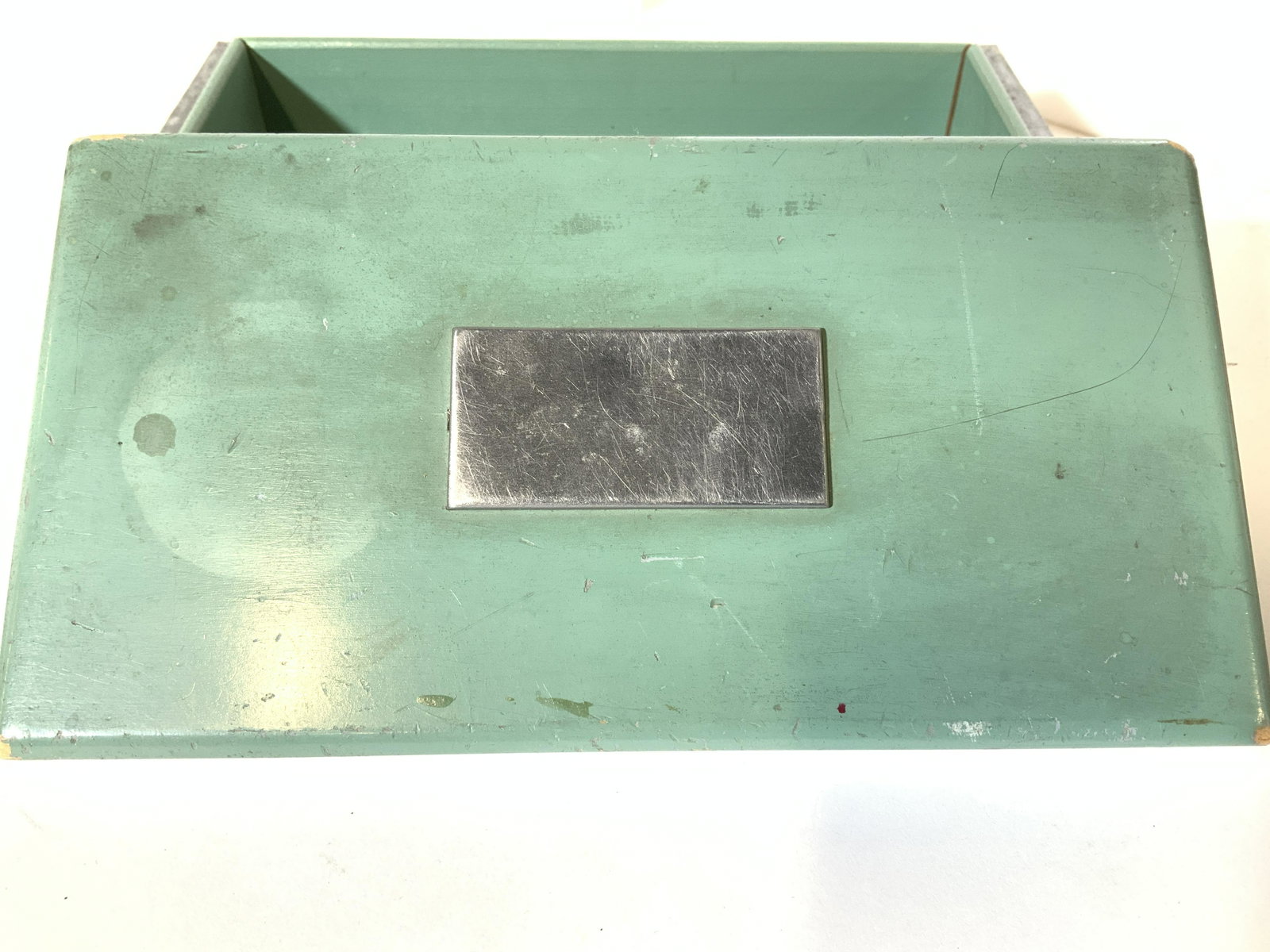 Metal over Wood Dresser/ Table Trinket Box: Handmade box, painted green wood with white metal sheet fold over bottom compartment. Engraving bar on lid. Box measures 7.25 x 3.75 in. Can be repainted to desired color. Keepsake box, wood and metal