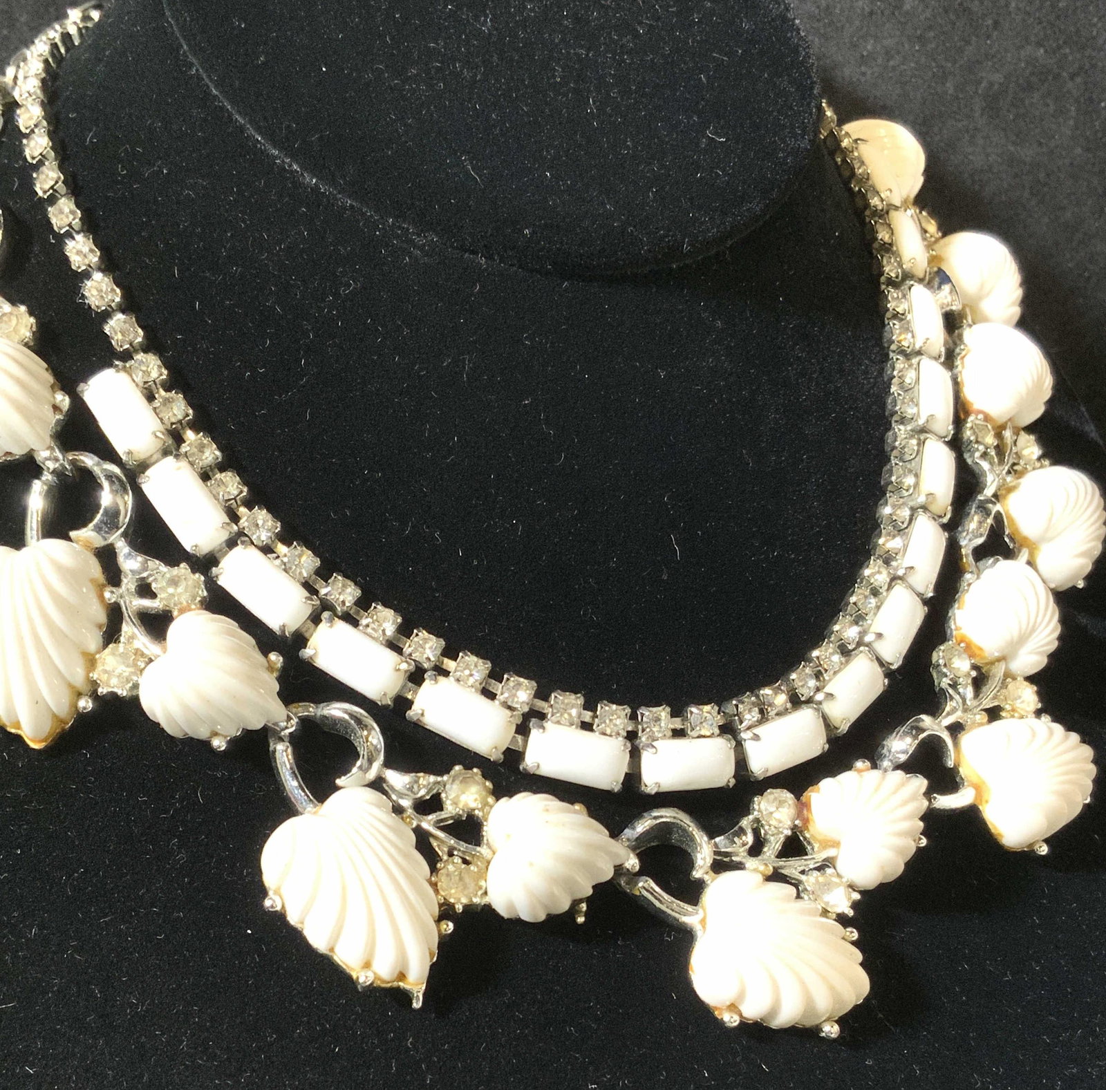 Group 2 White Bead & Rhinestone Vintage Necklaces: Choker/ collar necklaces, simple white cabochon beading on one with a row of prong set rhinestones, max. length 14 in., other necklace molded leaf beads in relief with accent rhinestones, some weight,