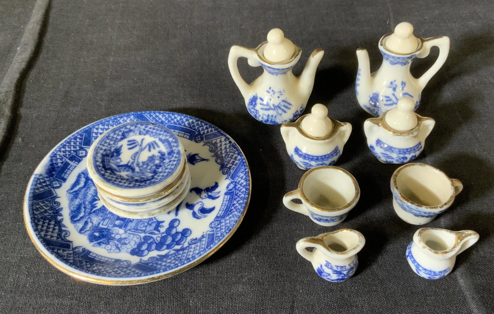 Ceramic Miniature Tea Set: Ceramic Miniature Tea Set, label to base of largest plate reads ‘Made in Taiwan ROC’, largest dish measures 3 5/8 inches in diameter, creamers measure 3/4 inches tall, surface wear consistent with