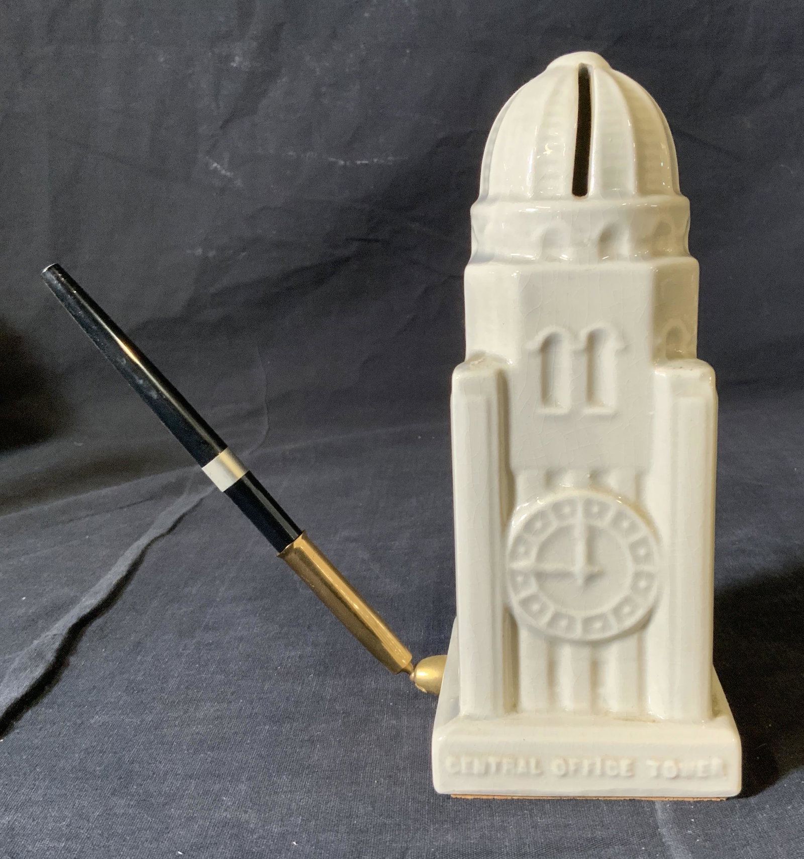 Williamsburgh Bank Tower Coin Bank & Pen Holder: Williamsburgh Bank Tower Coin Bank & Pen Holder, inscriptions read ‘The Williamsburgh Savings Bank’, ‘Tower of Strength’, ‘Central Office Tower’, measures 7 1/2 inches tall x 3 1/8 inches 