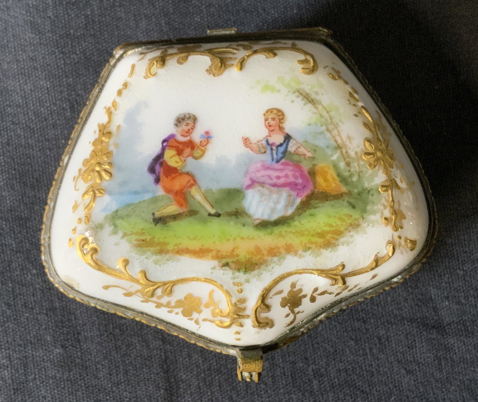 Marked Ceramic Trinket Pill Box: Marked Ceramic Trinket Box, crossed sword mark to base with ‘H’, measures 1 1/8 inches tall x 2 3/8 inches at widest point, some surface wear and tarnishing of metal, Marked, ceramics, trinket box