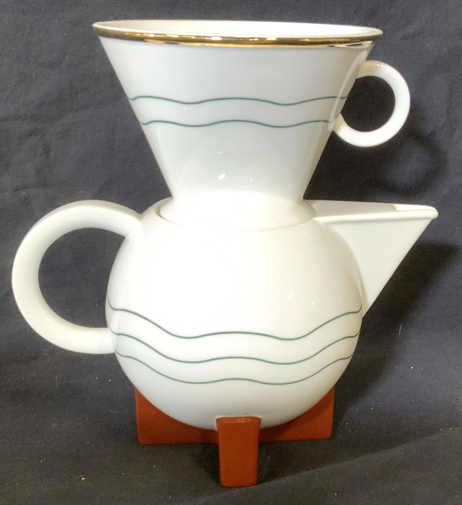 Porcelain Hand Drip Coffee Pot, Hallmarked: Porcelain coffee pot with lid includes porcelain hand dropper cone that fit right into coffee pot. Gilded rims, white porcelain. Hallmarked on verso SWID POWELL THE LITTLE DRIPPER, MICHAEL GRAVES 1987