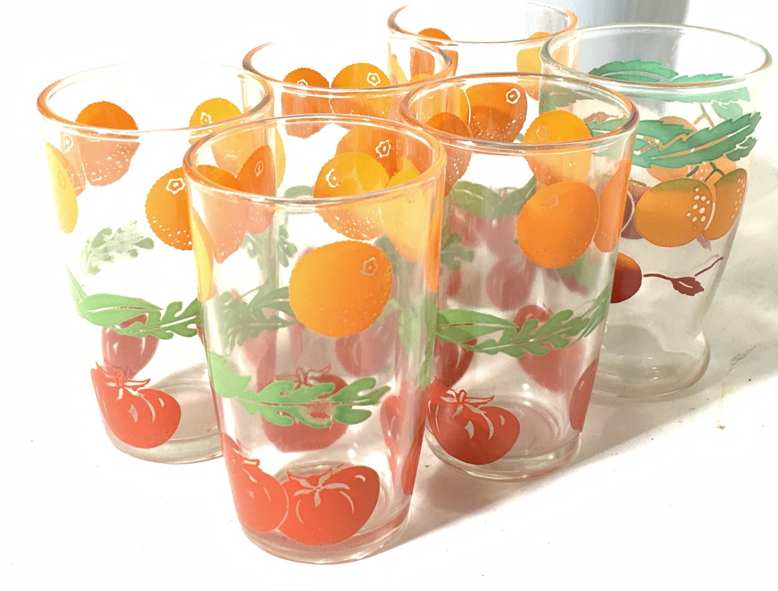 Set 6 Vintage Kitchen Juice Glasses: Vintage Juice glasses with stenciled oranges and tomatoes. 3.5 in ht, 2 in diameter. Property of Multi Generation Brooklyn Collector’s Estate. Barista, kitchenware, vintage juice glasses, vintage to