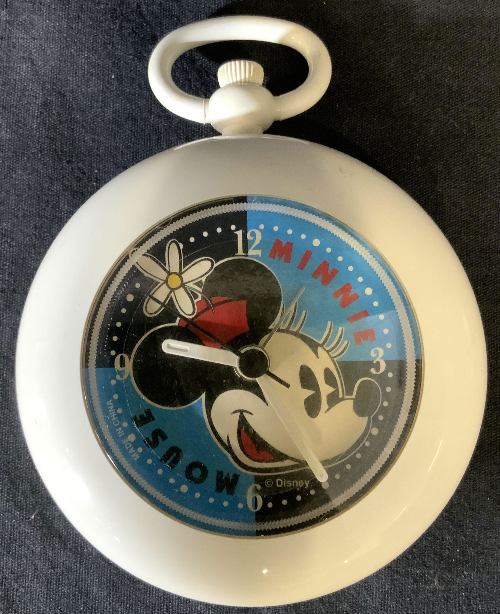 Vintage Disney Minnie Mouse Alarm Clock: Alarm clock is vintage. Clock face has image of Cartoon character Minnie Mouse. Piece reads DISNEY on lower right side. Clock face also has tones of blue & black. Piece measures approx 4.5 inches tall