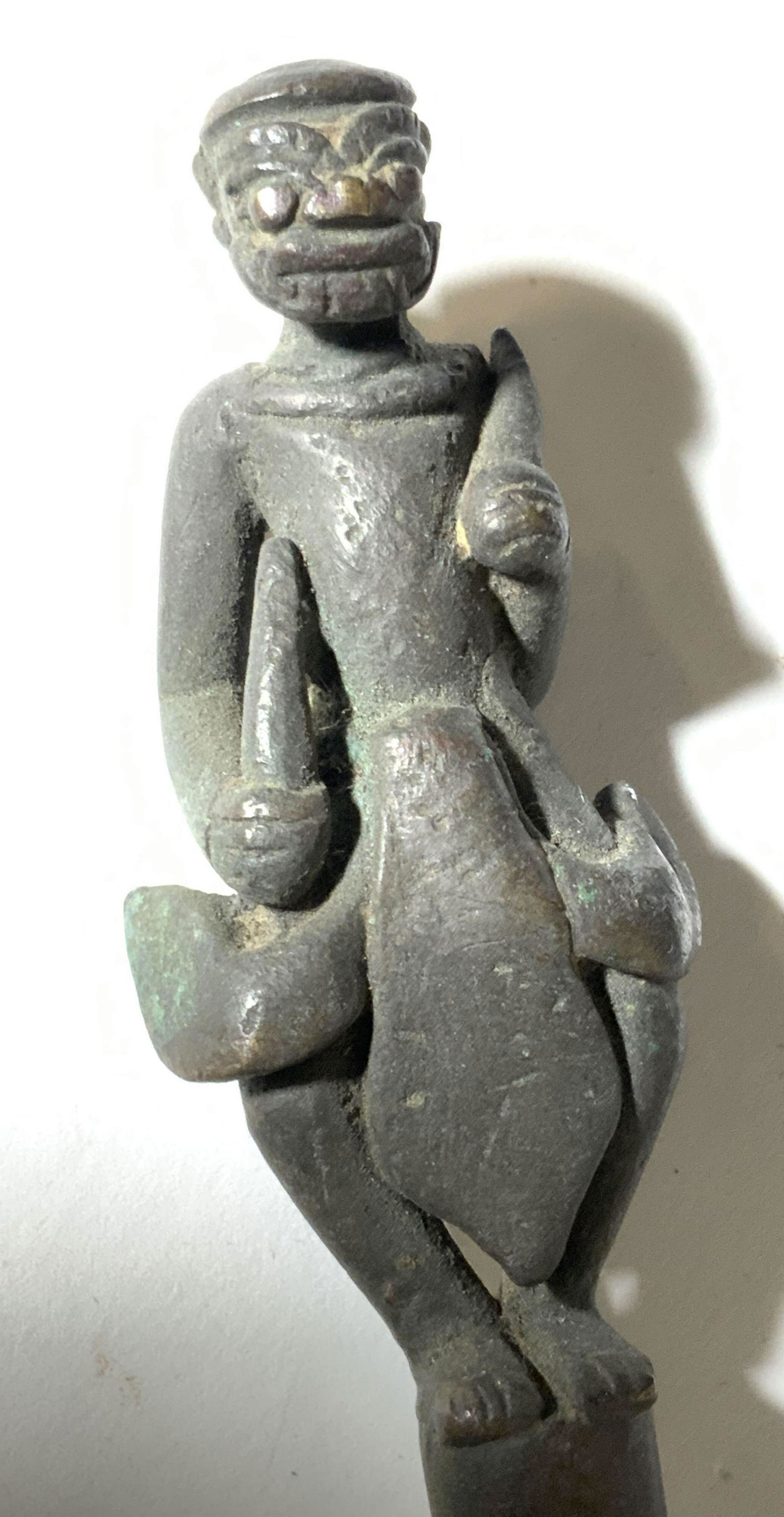 Vintage Metal Accessory With Etched Figural Topper: A metal accessory topped with a etched metal figural. The figural appears to be wearing armor and holding two small blades. Underside has an opening. Approx. 11L x 1.5W in. Decorative object, metal ac