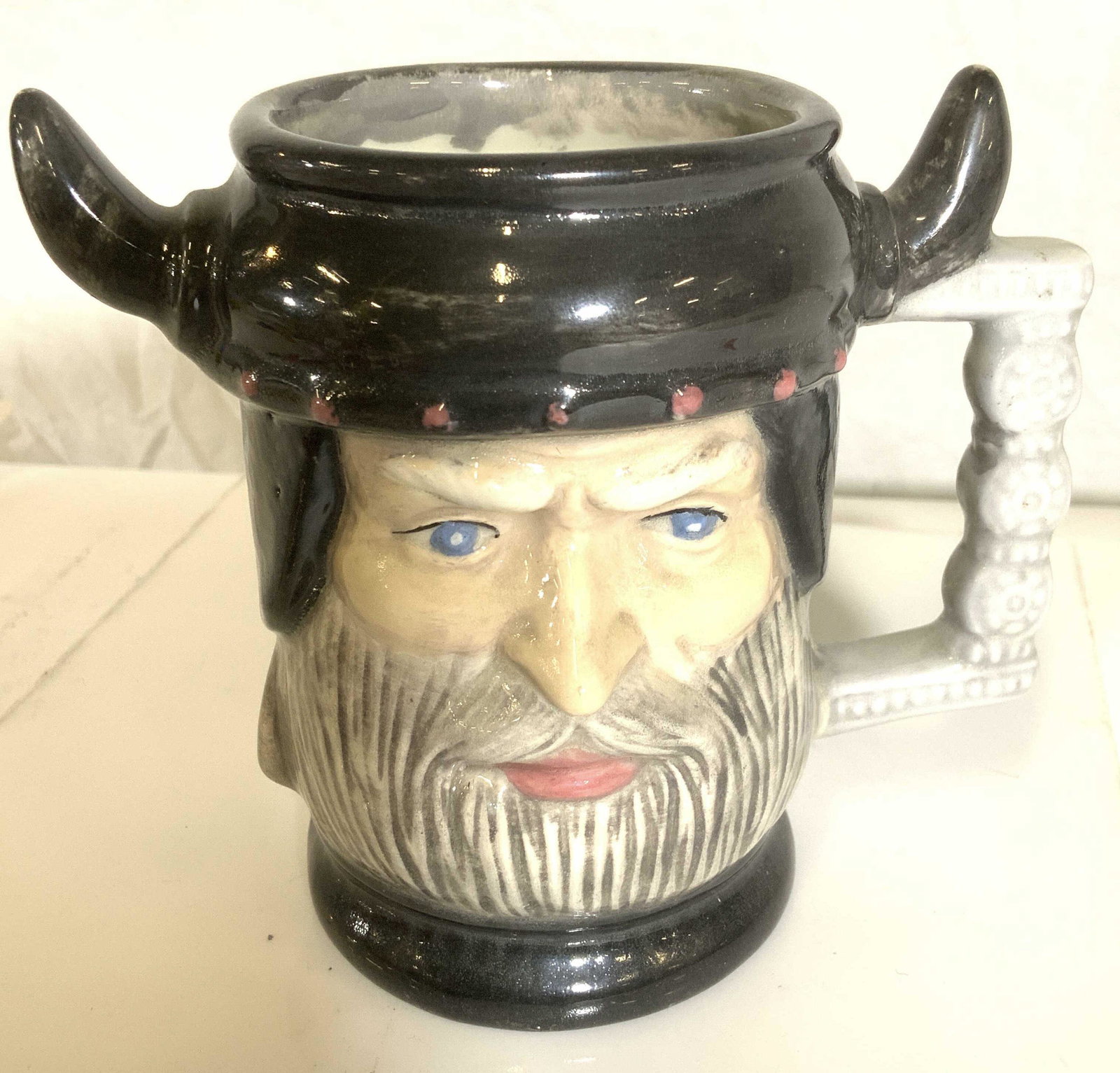 Signed Viking Face Ceramic Toby Style Mug: Handmade piece with face of VIKING MAN w blue eyes, grey beard and Viking hat. Signed Aronowitz ‘ 85 on verso. No surface issues. 5 in. Ht, 6 in W Property of Multi Generation Brooklyn Collector’s