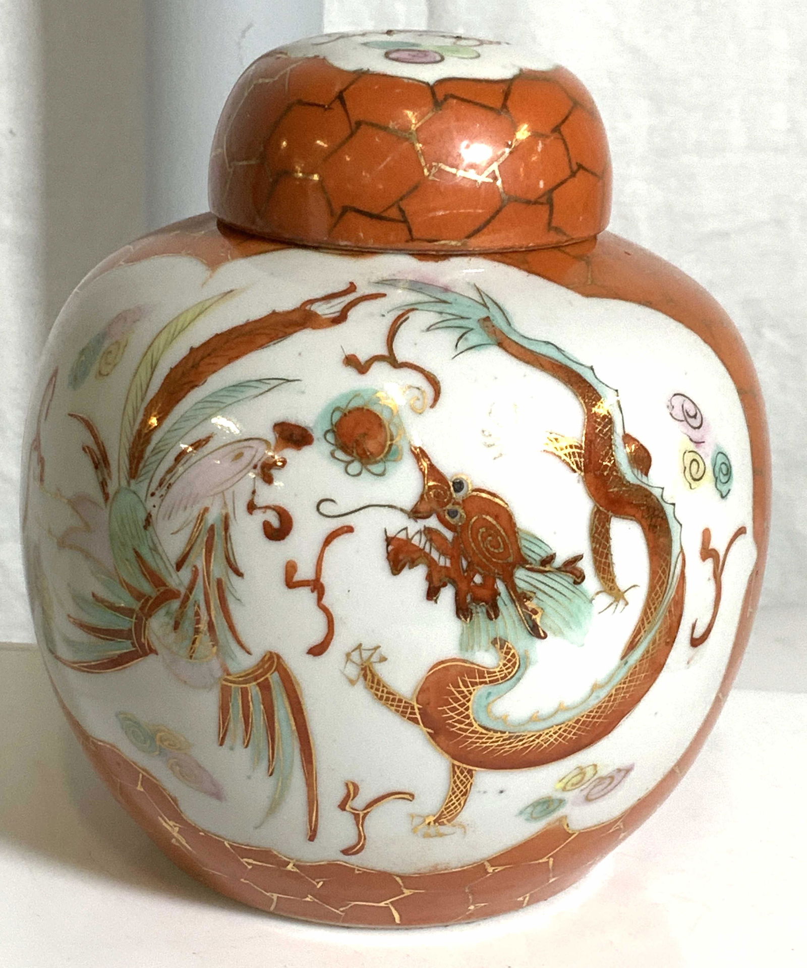 Hallmarked Dragon Motif Porcelain Ginger Jar China: Vintage porcelain orange and white ginger jar, large cartouche on both sides depicting Chinese dragon and pheasant. Gilt pattern on orange background and accepted witching illustration. Signed on vers