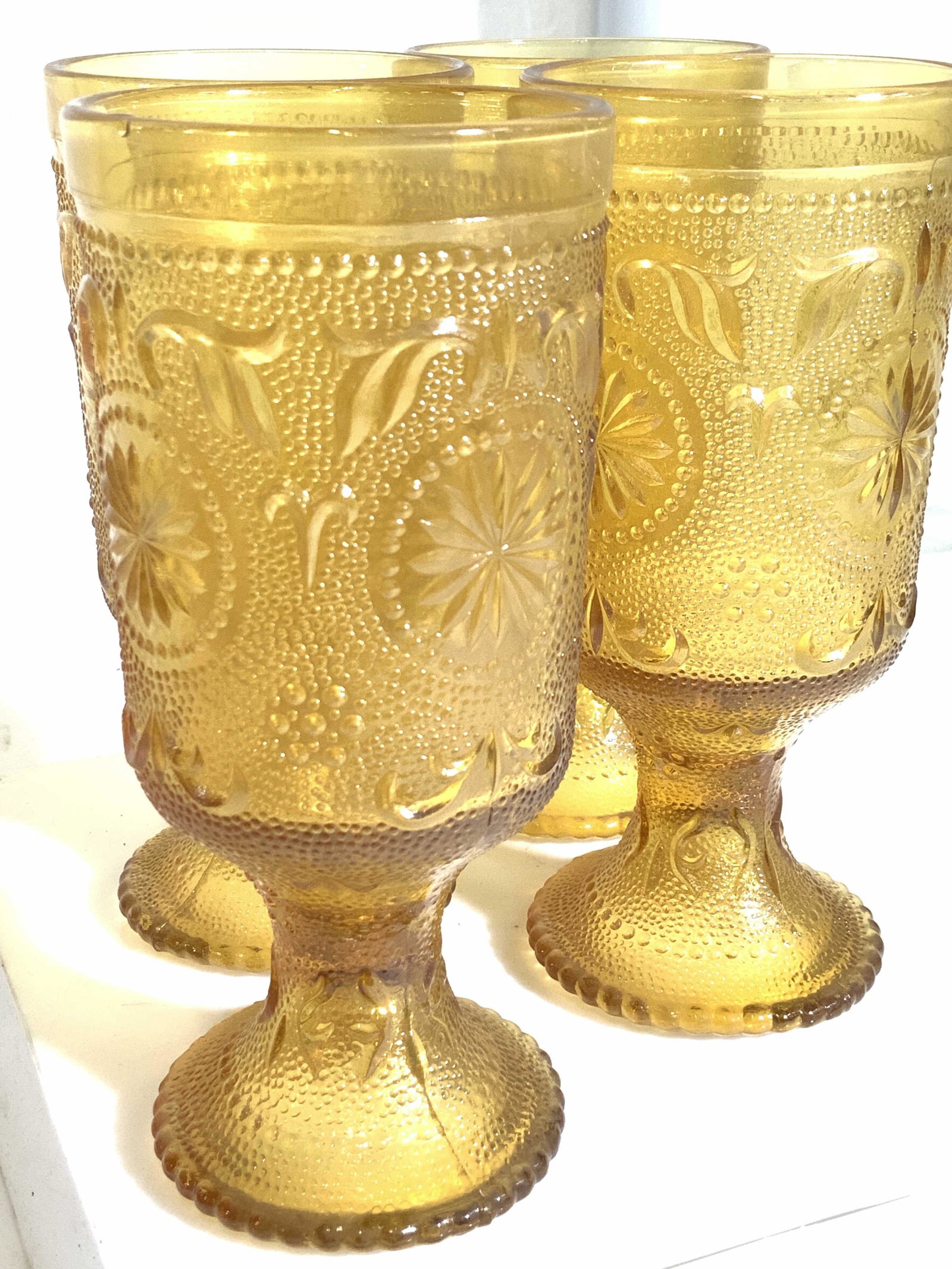 Set 4 Mid Century Depression Glass Goblets: Depression pedestal glass tumblers with orange color, embossed art nouveau pattern . Base is dotted glass. Tumblers measure 2.5 in wide, 6 in. Ht. Property of Multi generation Brooklyn Collector’s E