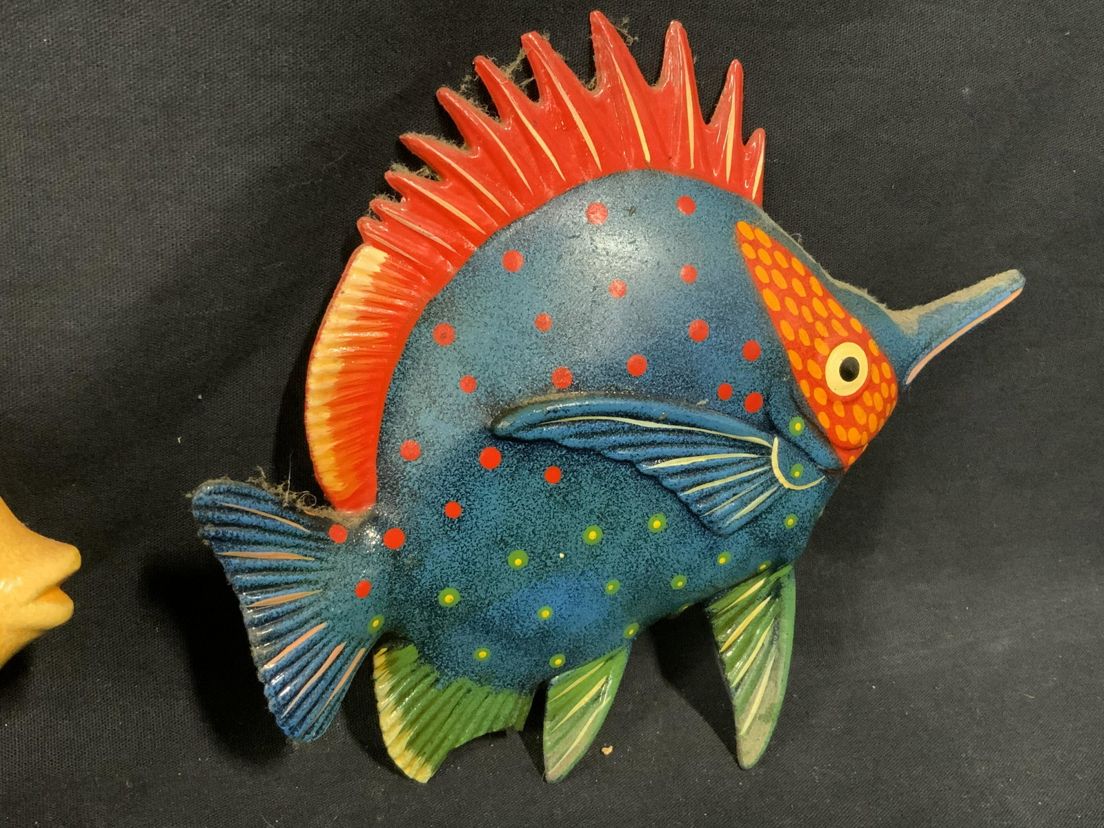 Group Lot 4 Composite Fish Figural Wall Plaques: Group lot 4 composite decorative wall fish, each has a tag to their reverse that reads ‘Made in China’, each is painted with its own design some cracks and wear to piece, largest of the four measu