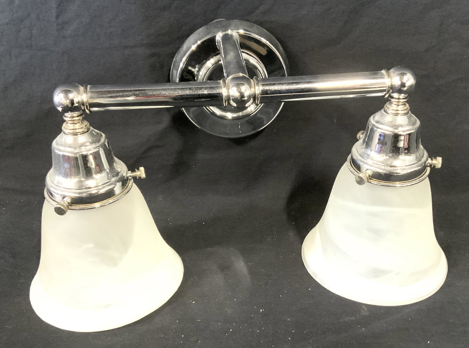 Double Light Chrome & Frosted Glass Wall Sconce: Modern Bell shaped frosted glass shades with chrome hardware. Dual light sconce. Perfect for bath room, foyers or mud room.. Wall plate is round, 4.75 in. diameter. Total length 15.5 in. Depth from wa