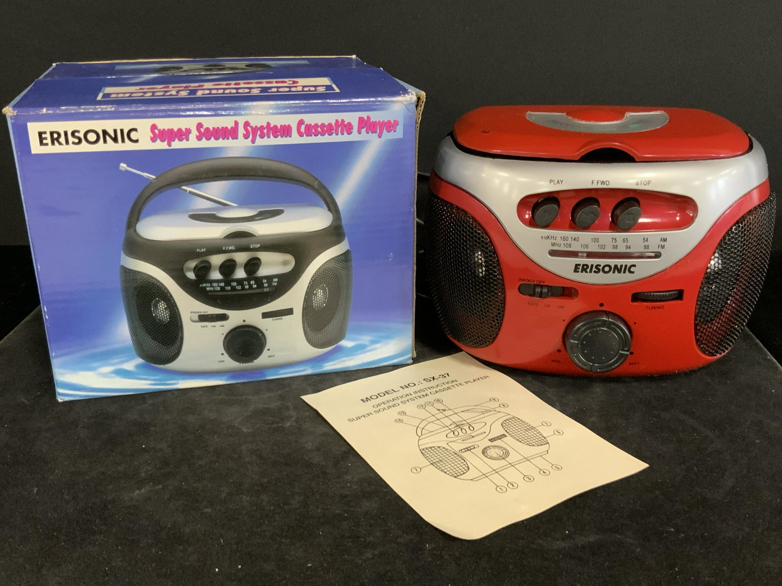 Collect ERISONIC CASSETTE PLAYER SX37 W/ Box: A collectible red Erisonic Super Sound System Casette Player that comes with its original box. Model SX37. Piece still has bubble wrap wrapping. Knobs and buttons are moveable / pushable. Has a black 