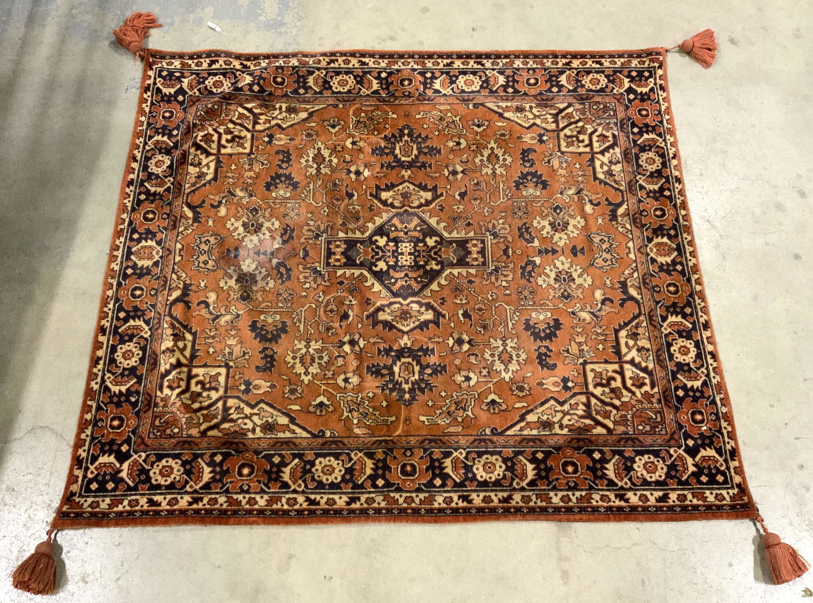 Vintage Wool Rug W Tasseled Corners: Rug is wool. Piece appears to be vintage. Rug has intricate multi toned floral, leaf & geometric detail. Corners have tassels. Piece measures approx 53 inches square. Rug, wool rug, vintage rug, tasse