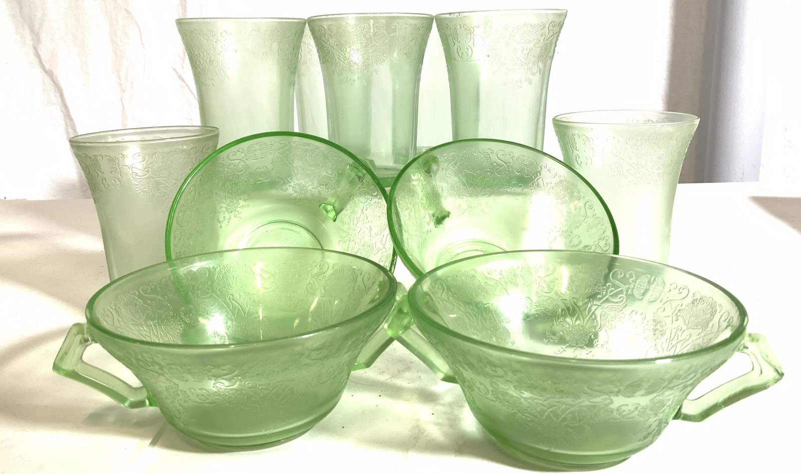 Set 11 Etched Retro Green Depression Glassware: Set of 4 bowls with handles and 7 drinking glasses. Etched pattern of Victorian scrolls and flowers, subtle tone on tone. This molded depression glass was popular in the 1930s, 40’s and 50’s. Set