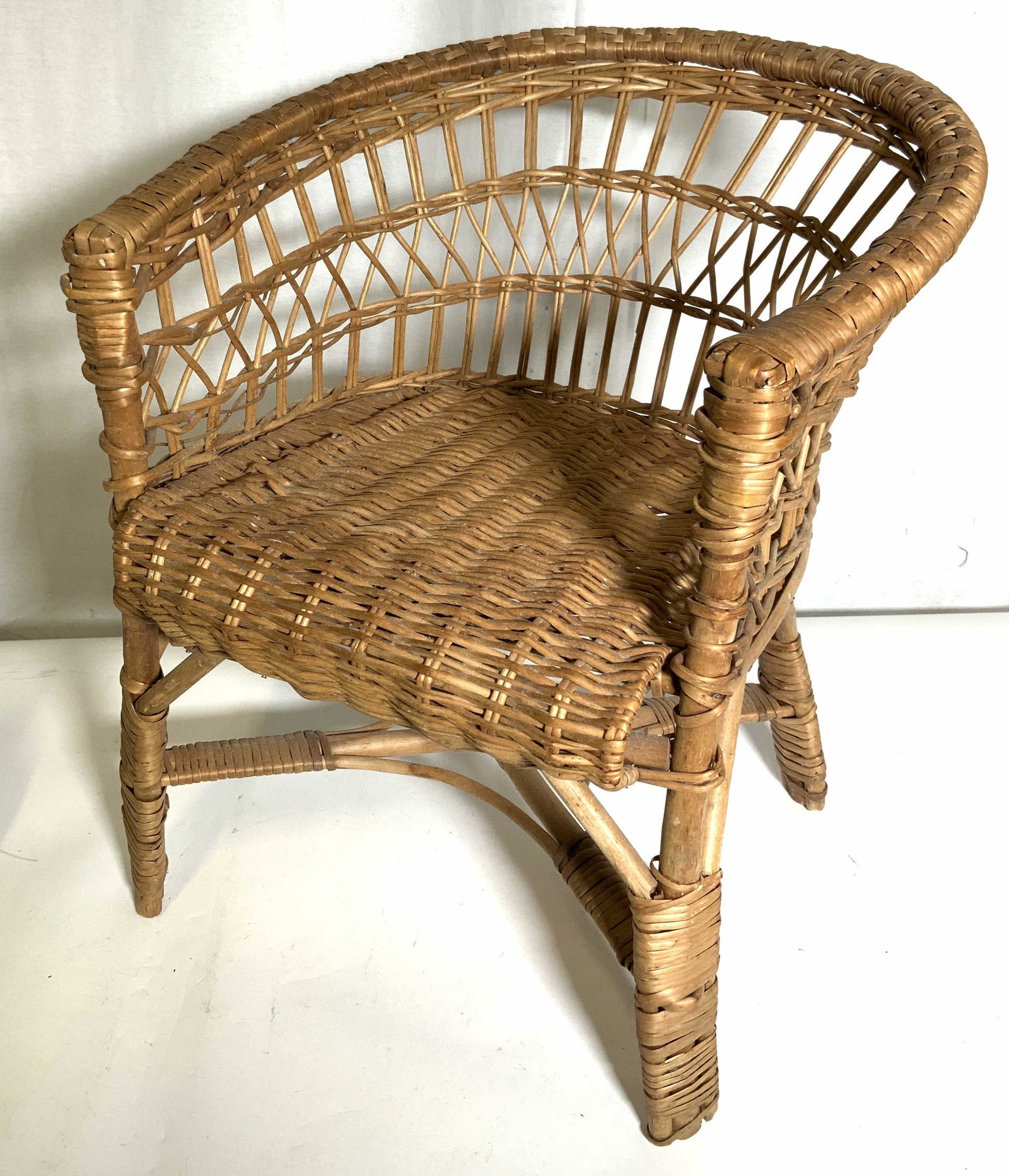 Vintage Woven Wicker Children’s Chair: Vintage, possibly antique, woven wicker chair. Woven wicker over a wooden frame. The chair is Children’s sized. Measures approx 18 inches H, 14.5 inches W, and 11.5 inches deep. Wear is consistent w