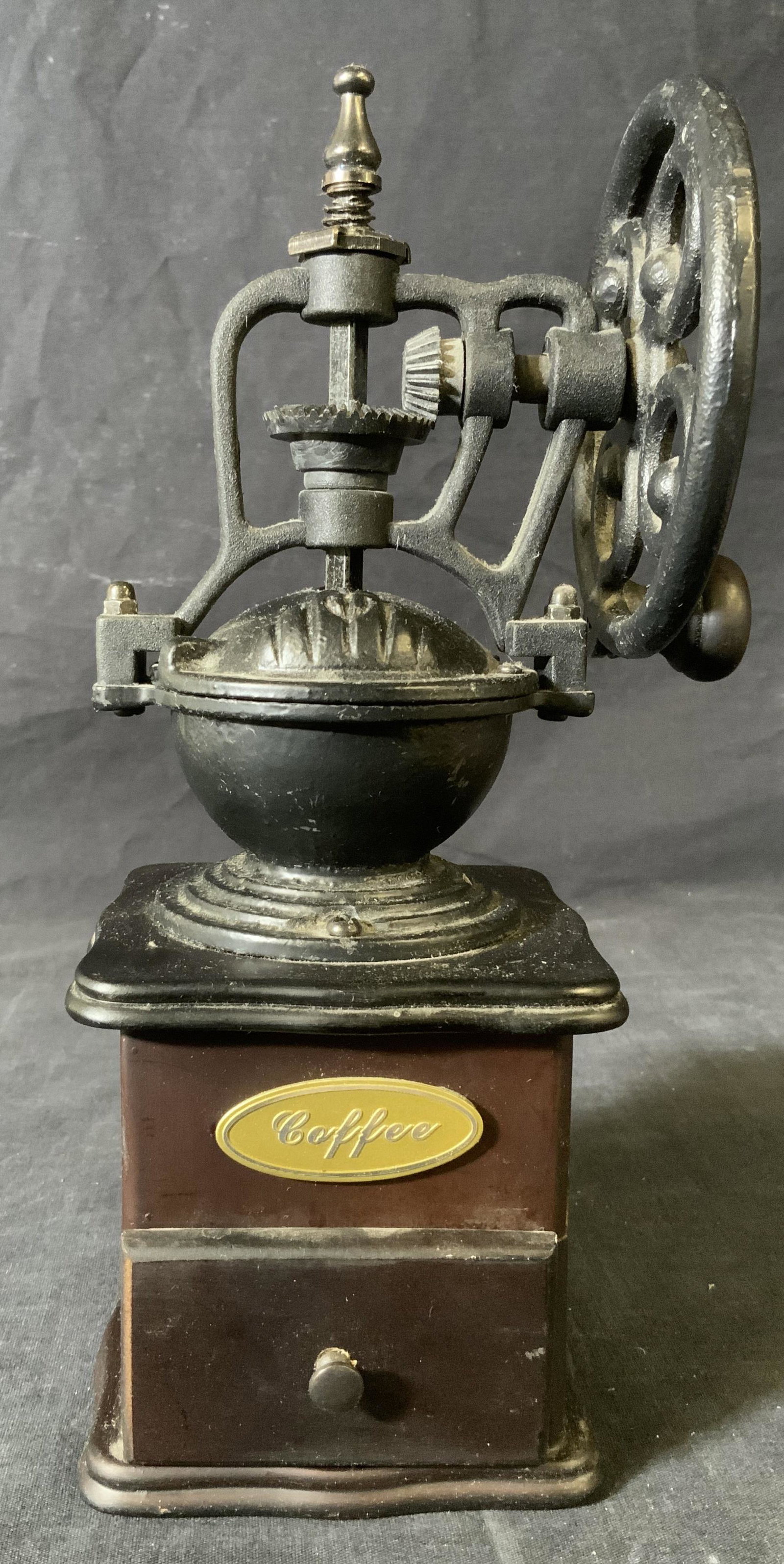 Cast Iron & Wood Coffee Grinder: Cast Iron & Wood Coffee Grinder, inscription reads ‘Coffee’, measures 11 1/8 x 4 1/8 inches at widest point, some surface wear from use, Property of multi generation Brooklyn collector’s estate 